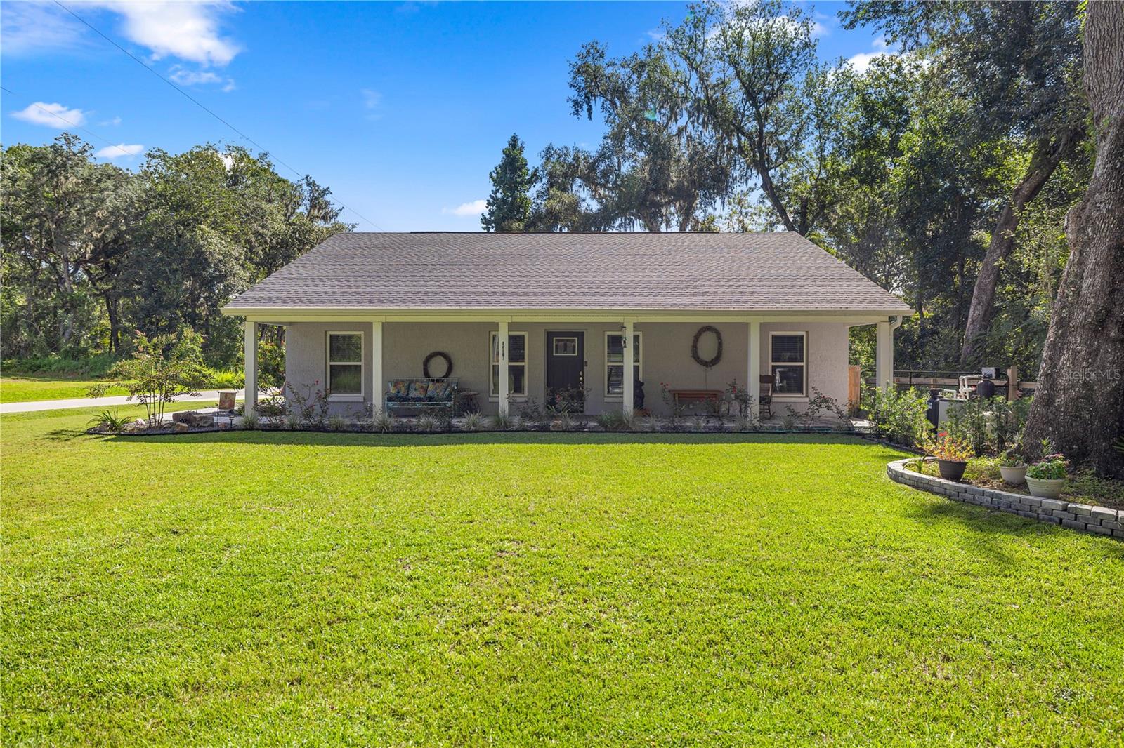 ~~Farmhouse Charm Meets Modern Living~~ Welcome to this stunning 3-bedroom, 2-bath farmhouse-style home built in 2022 with over $50,000 in upgrades!!! ~NO HOA~ From the moment you arrive, you’ll notice the beautiful curb appeal that carries through into the spacious, fully fenced backyard. Inside, the bright and open floor plan features a kitchen with quartz countertops, a large pantry, soft-close drawers, upgraded sink, new light fixtures, and a solar tube for natural light. An inside laundry room with sink, extra storage, and a folding table adds everyday convenience. The primary suite is a true retreat with a walk-in closet, dual vanity sinks, and a sleek walk-in shower. Step outside to enjoy your backyard oasis—complete with custom brick pavers, professional rock landscaping, a large patio with pull-down shades, ceiling fan, and plenty of room for entertaining. There’s also space to park your boat or RV, plus extra driveway parking with asphalt millings. Additional upgrades include: Saltwater filtration system, Commercial-grade water heater, Whole-house gutters, Aluminum attic stairs for easy access, and Convenient garage entry from the backyard. This home is the perfect blend of modern finishes, thoughtful upgrades, and timeless farmhouse style—ready for you to move in and enjoy! Best of all, it’s just minutes to Publix, shopping, restaurants, doctors, and more!