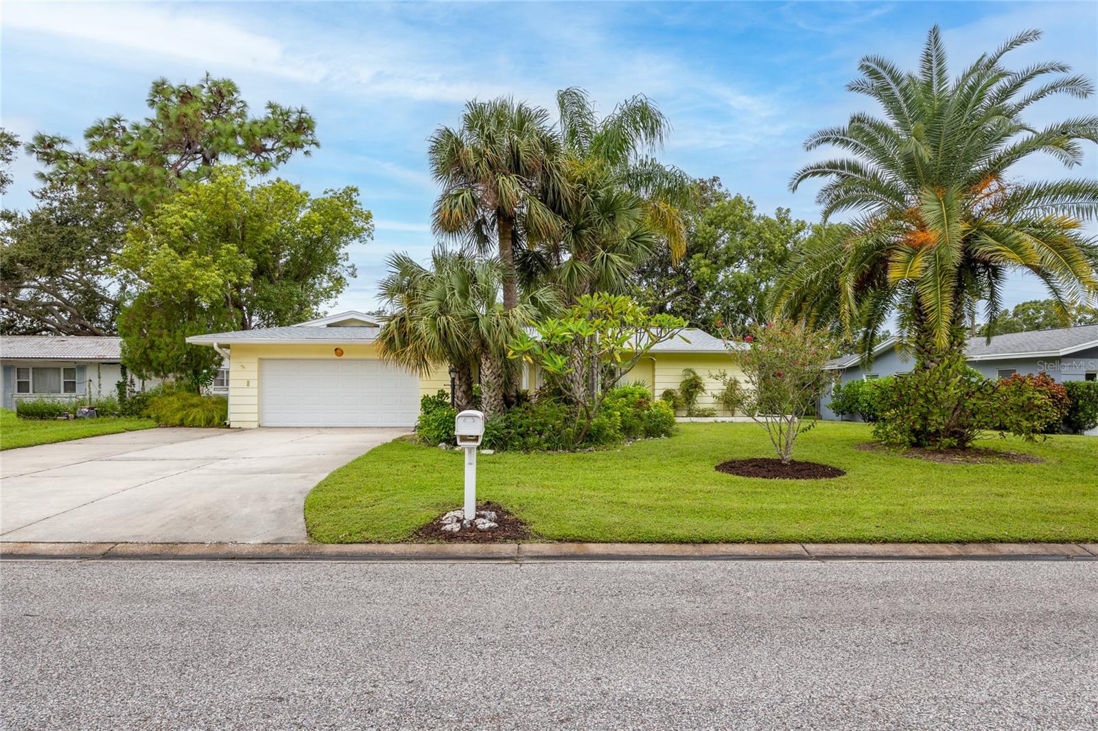 Welcome to this home filled with amazing potential, located in Fairway Estates, one of Dunedin’s most sought-after golf cart approved neighborhoods. This spacious 4-bedroom, 2-bathroom residence offers a desirable split bedroom floor plan that ensures privacy for the primary suite while maintaining a natural flow throughout the living spaces.
The home features both a formal living room and a more casual family room, creating flexibility for entertaining, relaxing, or setting up a home office. The kitchen is open to the family room and includes a convenient pass-through window to the lanai, making gatherings easy and enjoyable. The large 200 square foot covered and enclosed lanai, while not currently included in the 1,753 heated and cooled square footage, could easily be converted to additional air-conditioned living area, significantly expanding the footprint of the home and its value.
The primary suite includes its own ensuite bathroom for convenience and comfort, while the additional three bedrooms and full bath offer plenty of room for family or guests. Beautiful wood flooring runs throughout the main living areas and the primary bedroom, adding warmth and charm. The secondary bedrooms feature classic terrazzo floors and tile, with the terrazzo ready to be refinished to restore its mid-century modern appeal.
Major updates provide peace of mind, including a roof replaced in 2023, HVAC system in 2024, water heater in 2019, and updated windows installed between 2011 and 2013. The property is located in Flood Zone X where lenders do not require flood insurance and a Non-Evacuation zone, giving homeowners the benefit of reduced insurance concerns and security during storm season. Fairway Estates has an active but VOLUNTARY/Optional Civic Association ($65 for the entire year) and NO DEED Restrictions! It is a great active/social community to live in!
This home is all about location as much as it is about opportunity. Dunedin is known for its small-town charm with big lifestyle benefits. Just minutes away you’ll find the recently restored Donald Ross-designed Dunedin Golf Club, Honeymoon Island and Caladesi Island State Parks, and the miles-long Pinellas Trail. Nearby Highlander and Hammock Parks offer beautiful green space, while Dunedin Community and Fine Arts Centers provide endless activities and cultural experiences. Best of all, you are just a short golf cart ride to Delightful Downtown Dunedin with its vibrant mix of shops, restaurants, breweries, and festivals.
With its solid foundation, recent system updates, and unmatched location, this property is the perfect opportunity to create your dream home while enjoying everything that makes Dunedin such a special place to live.