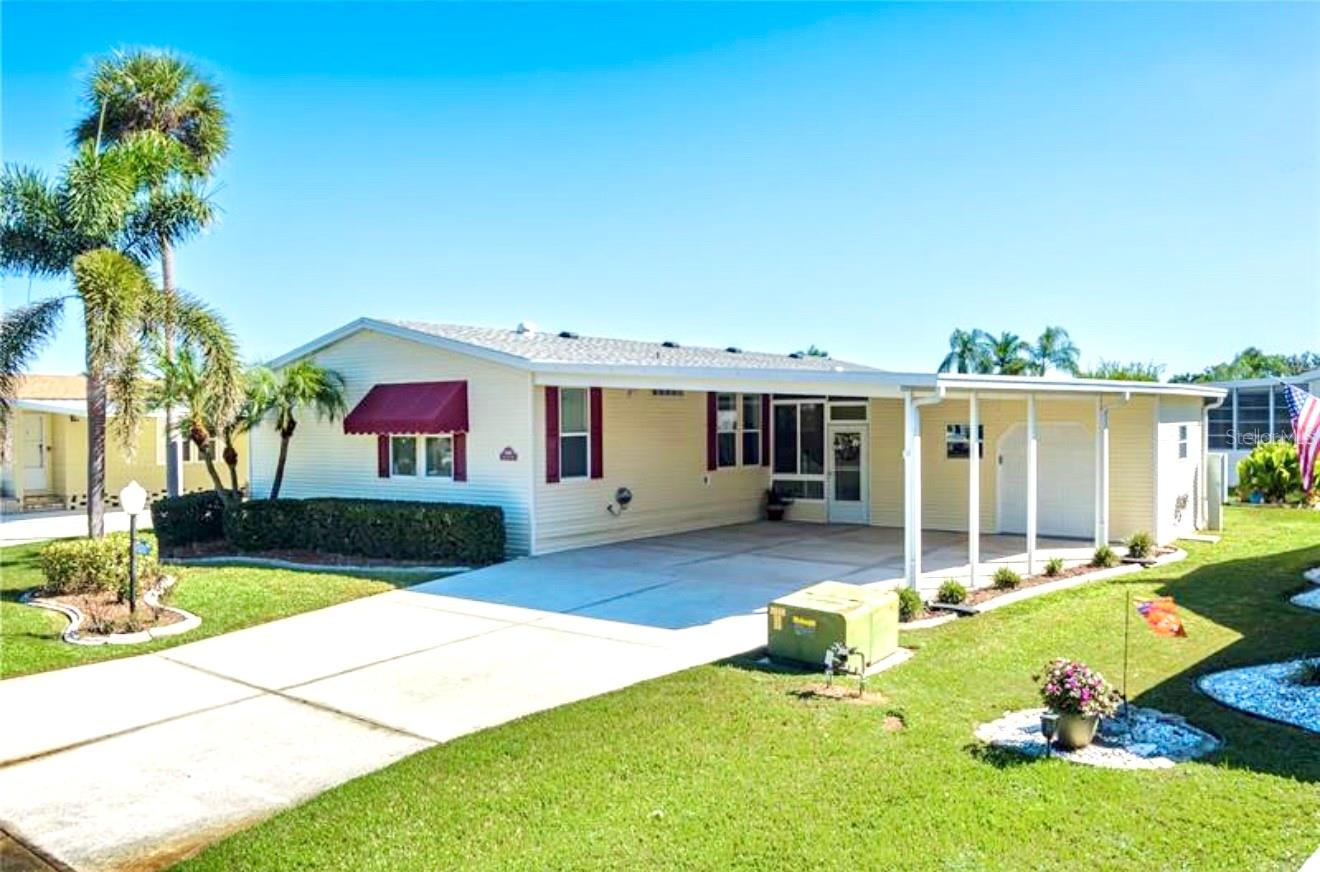 Well-Maintained 3BR Palm Harbor Home with New Roof & A/C! Welcome to this beautifully maintained 2002 Palm Harbor home located in the desirable 55+ land owned community of Imperial Lakes Estates. This 3-bedroom, 2-bathroom home offers 1,566 sq. ft. of living space and nearly 2,900 sq. ft. under roof, providing plenty of room to relax and entertain. Step inside to find high ceilings and plenty of natural light throughout. The galley-style kitchen features abundant cabinet space, a pantry, and an inviting breakfast area, ideal for casual meals or morning coffee. The formal dining area greets you as you enter the home and flows into a spacious living room, which makes it perfect for entertaining. The primary suite includes a large closet plus an ensuite bath featuring dual sinks, a walk-in shower, and an additional walk-in closet. Both guest bedrooms are generously sized, and the guest bath offers a tub/shower combination. Additional highlights include an indoor laundry room and abundant storage throughout the house. Imagine being able to enjoy Florida living year-round in the large enclosed lanai. The workshop/garage provides ample space for storage and a remote control door for easy golf cart parking. A two-car covered carport and large driveway offer plenty of parking. Recent updates include a new roof and new A/C. The Imperial Lakes Estates community is truly a wonderful place to reside, offering an abundance of activities and amenities such as two heated pools and a spa, tennis and pickleball courts, shuffleboard, a billiard room, library, and picnic area. Throughout the year, residents can enjoy numerous social events that make it easy to connect with neighbors and build lasting friendships. Conveniently located near the interstate, shopping centers, restaurants, and medical facilities and just a short drive to beautiful sandy beaches and the iconic Skyway Bridge you’ll have everything you need close by.