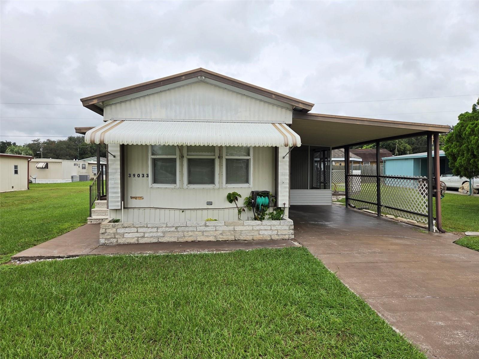 Own the land and this cool little manufactured home. The lot is 64' x 85', bigger than most, and has a gazebo and utility shed.
The home has two bedrooms, one bath and an airconditioned Florida room that includes the washer and dryer hook-up. The eat-in kitchen is very large and sports a breakfast bar. There are exterior awnings, a metal roof a screened porch and a car-port. There is NO HOMEOWNER'S ASSOCIATION. No pet or age restrictions.