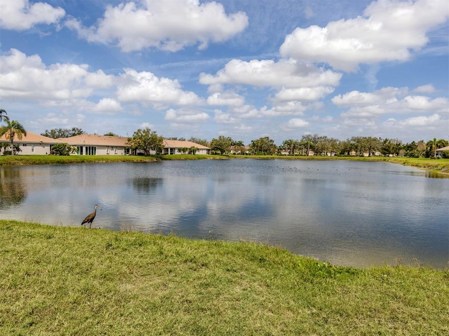 Charming WATERFRONT villa in Lakeridge Falls, a Sarasota Gem! This end unit, 2 bedroom plus den home boasts extra square footage with the enclosed lanai space with hurricane windows AND fully air conditioned. The beautiful full lake view offers lots of nature and tranquility. Tile flooring in the main areas of the home give the home spaciousness and easy maintenance. The primary bedroom features an updated en-suite bath and walk-in closet. The second bedroom and guest bath are at the front of the home- offering privacy for guests. The kitchen has a convenient pass through window and breakfast area. The community of Lakeridge Falls offers a large range of amenities. The recreation and social center features a clubhouse which recently underwent a major renovation. The grand salon has been enlarged to accommodate large gatherings and meetings. The fitness center is located in a large space in the clubhouse. Immediately adjacent to the clubhouse is the pool annex building which now contains two billiards tables, a library and two computer stations with free Wi-Fi. Our outdoor amenities include a heated resort-style pool, spa, and two bocce ball courts. Our activities include a variety of card games like mahjong, poker, and bridge, bingo nights. Other activities include bocce, table tennis, yoga/stretch classes, as well as, water aerobics. There is even their own lakeside beach! The location is perfect! Close to dining, restaurants, SRQ and the University shopping complex and the expansive Mote Marine Aquarium. So convenient to SRQ.