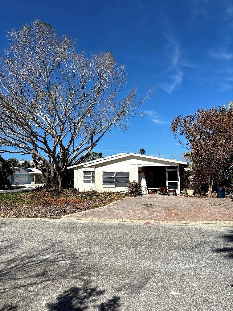 Beach Bungalow on a corner lot with 2 bedrooms and 1.5 baths only 2 blocks from the beach! Fantastic water views! This home was flooded during Hurricane Helene. It has been remediated and is ready for the new buyer to remodel. There is a bonus room for an office or man cave. The roof was installed in October, 2021. With sweat equity this is a terrific place to live. Enjoy beach life!