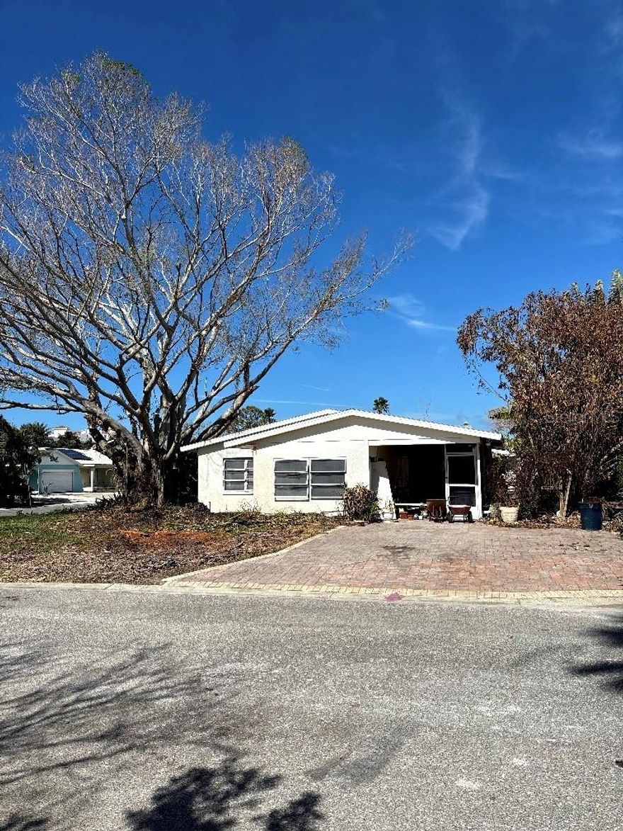Beach Bungalow on a corner lot with 2 bedrooms and 1.5 baths only 2 blocks from the beach! Fantastic water views! This home was flooded during Hurricane Helene. It has been remediated and is ready for the new buyer to remodel. There is a bonus room for an office or man cave. The roof was installed in October, 2021. With sweat equity this is a terrific place to live. Enjoy beach life!