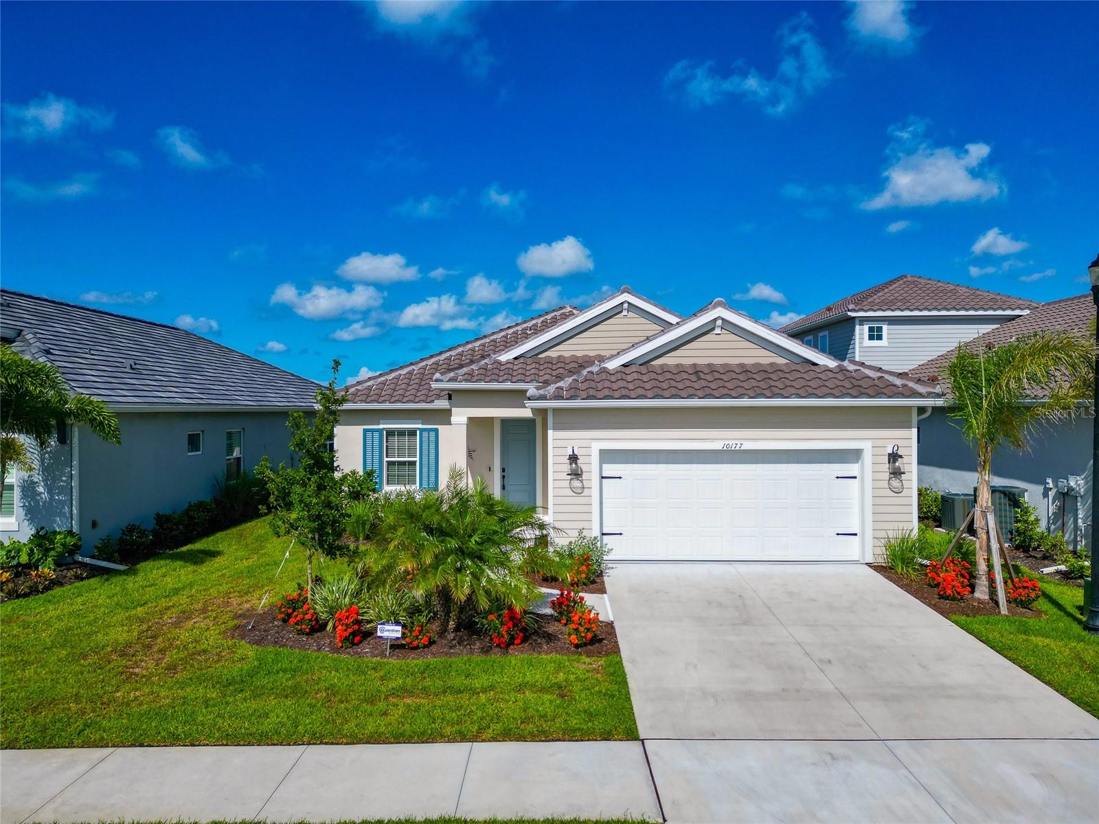 Welcome to your dream home in the heart of Sarasota’s sought-after Grand Park community! This stunning 3 bedroom, 2.5 bathroom lake front retreat is only one year old and feels like a model home, bursting with luxury upgrades, timeless finishes, and thoughtful design throughout. Tucked beneath shady palm trees and surrounded by lush Florida landscaping, you’re greeted by a spacious 2-car garage and inviting curb appeal. Step inside to an open and airy floorplan featuring tray and coffered ceilings, designer light fixtures, and sleek tile flooring throughout—no carpet here! The expansive living area is perfect for entertaining, anchored by a unique wooden TV backdrop that adds warmth and character to the space. Overlooking it all is the chef’s kitchen, where no detail has been overlooked—quartz countertops, stainless steel appliances, subway tile backsplash, ample cabinetry, a butler-style pantry with extra storage and beverage fridge, and a large center island ideal for coffee, casual meals, or cocktails with friends. Just off the kitchen, the cozy dining room is ready for anything—from laid-back breakfasts to elegant dinner parties. When it’s time to relax, retreat to the luxurious primary suite, thoughtfully separated from the guest rooms for privacy. It features dual walk-in closets and a spa-inspired en-suite with dual vanities and a massive walk-in shower for ultimate relaxation. Two additional guest bedrooms give you plenty of flexibility for family, visitors, or hobbies, and the bonus room/office is perfect for remote work, a sunny art studio, or even a peaceful indoor garden nook. Outside, unwind on the screened-in lanai while enjoying serene views of the pond and vibrant Florida sunsets. With no rear neighbors, your backyard offers unmatched privacy—perfect for pets, play, or peaceful lounging. As part of the Grand Park lifestyle, enjoy access to a beautiful clubhouse, resort-style pool, playground, tennis and pickleball courts, and scenic sidewalks for walking and biking. All just minutes from top-rated schools, major shopping, dining, and the world-renowned beaches of Sarasota. This isn't just a house—it’s a lifestyle. Completely move-in ready and waiting for you—schedule your private showing today before it's gone!