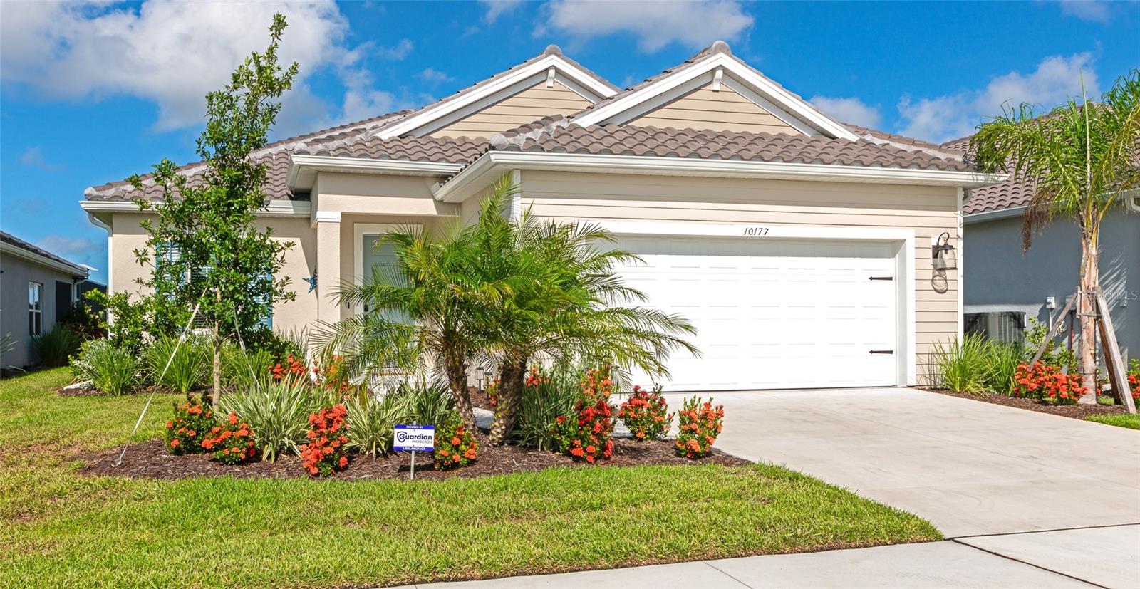Welcome to your dream home in the heart of Sarasota’s sought-after Grand Park community! This stunning 3 bedroom, 2.5 bathroom lake front retreat is only one year old and feels like a model home, bursting with luxury upgrades, timeless finishes, and thoughtful design throughout. Tucked beneath shady palm trees and surrounded by lush Florida landscaping, you’re greeted by a spacious 2-car garage and inviting curb appeal. Step inside to an open and airy floorplan featuring tray and coffered ceilings, designer light fixtures, and sleek tile flooring throughout—no carpet here! The expansive living area is perfect for entertaining, anchored by a unique wooden TV backdrop that adds warmth and character to the space. Overlooking it all is the chef’s kitchen, where no detail has been overlooked—quartz countertops, stainless steel appliances, subway tile backsplash, ample cabinetry, a butler-style pantry with extra storage and beverage fridge, and a large center island ideal for coffee, casual meals, or cocktails with friends. Just off the kitchen, the cozy dining room is ready for anything—from laid-back breakfasts to elegant dinner parties. When it’s time to relax, retreat to the luxurious primary suite, thoughtfully separated from the guest rooms for privacy. It features dual walk-in closets and a spa-inspired en-suite with dual vanities and a massive walk-in shower for ultimate relaxation. Two additional guest bedrooms give you plenty of flexibility for family, visitors, or hobbies, and the bonus room/office is perfect for remote work, a sunny art studio, or even a peaceful indoor garden nook. Outside, unwind on the screened-in lanai while enjoying serene views of the pond and vibrant Florida sunsets. With no rear neighbors, your backyard offers unmatched privacy—perfect for pets, play, or peaceful lounging. As part of the Grand Park lifestyle, enjoy access to a beautiful clubhouse, resort-style pool, playground, tennis and pickleball courts, and scenic sidewalks for walking and biking. All just minutes from top-rated schools, major shopping, dining, and the world-renowned beaches of Sarasota. This isn't just a house—it’s a lifestyle. Completely move-in ready and waiting for you—schedule your private showing today before it's gone!