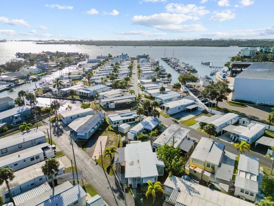 Welcome to Sea Horse Mobile Home Park, where a rare opportunity awaits to own a DEEDED lot in a desirable 55+ waterfront community, featuring a generously sized 2,770 sq ft parcel.  The low $250 monthly HOA fee includes a heated community pool, clubhouse access, lawn maintenance, water, sewer, and trash service.  This property is being marketed and sold as a tear-down. The home and surrounding community were impacted by recent hurricane flooding, and no representations or assurances are being made regarding the ability to renovate the existing structure under FEMA guidelines.  Sea Horse Park is an active adult waterfront community offering a prime location just minutes from award-winning Gulf BEACHES, the VA Hospital, popular shopping including Target and Walmart, and a wide selection of local restaurants. Come build your dream home near the beaches!!  More to love: Community BOAT RAMP, shed on the property, established parking, wide lot, and LOCATION!!  Cash Only.  55+