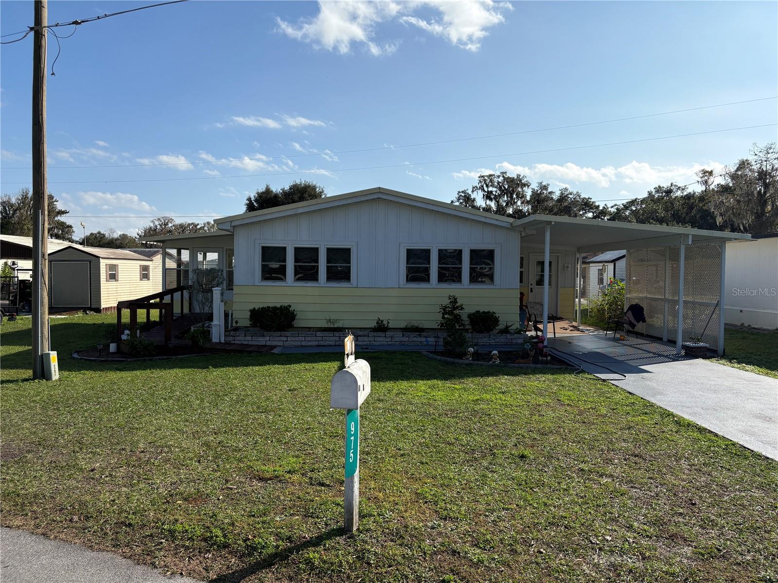 This a very nice doublewide mobile home with a Florida Room addition and a Laundry room addition to total over 1300 square feet. This home is very well maintained and has recent updated windows, recent septic system, ramp access from carport for easy entry and much more. The home is situated close to a shared lakefront boat launch and common area that offers deeded lake access to all property owners in the park. This mobile home neighborhood is the premier mobile home community in Lake Panasoffkee. The home sits on an oversized lot and offers easy access to the waterfront. The home will be mostly furnished and some items will be negotiable. Motivated Seller!