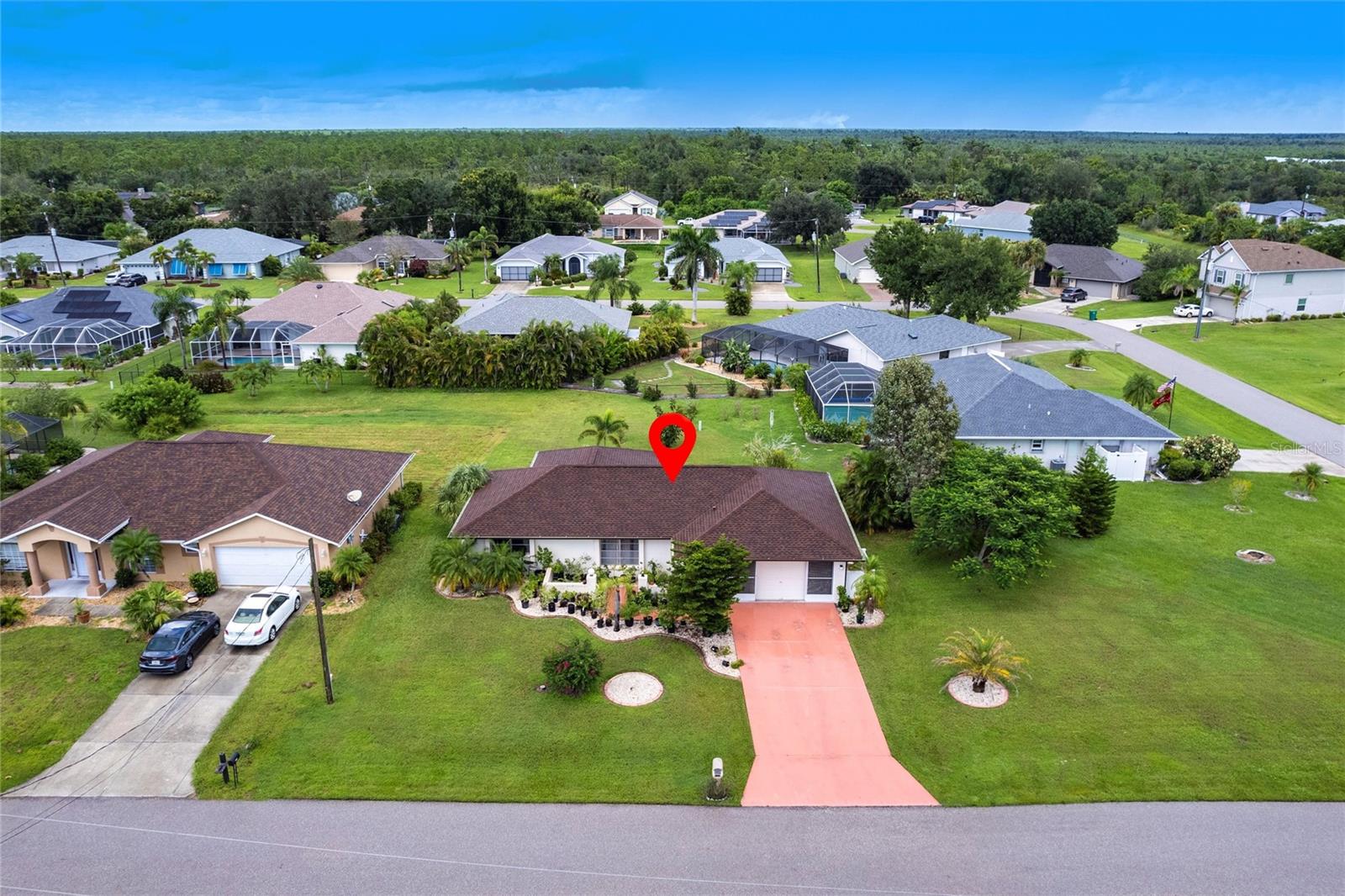 TENANT IN PLACE - Perfect opportunity to own this 2-bedroom, 2-bathroom home with an attached 2-car garage, located in the desirable deed-restricted Deep Creek Section 20 neighborhood. Offering 1,315 square feet of living space, this home sits on an oversized lot with plenty of room to add a swimming pool. Step inside to a bright and open living/dining area featuring tiled floors throughout for easy maintenance, high ceilings, and a seamless flow into the spacious kitchen. The kitchen is the heart of the home—showcasing white cabinetry with modern hardware, granite countertops, a large island with sink and breakfast bar seating, pendant lighting, and stainless steel appliances including a double-door refrigerator, smooth-top range, and built-in microwave. Ample storage, a built-in wine rack, and generous counter space make this kitchen as functional as it is stylish. The primary suite features a walk-in closet and an updated bathroom with a tiled walk-in shower, glass doors, and single-sink vanity with matching glass tile backsplash. A guest bedroom with a ceiling fan and abundant closet space, along with a fully updated guest bath, provide comfort and convenience for family and friends. The 2-car garage includes laundry space, additional storage, a garage door opener, and retractable screen door. Enjoy outdoor living in the spacious screened-in lanai with ceiling fan, and lighting overlooking a large backyard. Additional features include a new A/C and roof in 2023. water heater is 2009, hurricane shutters. Located just minutes from Deep Creek Golf Course, parks, shopping, dining, I-75, US-41, and area beaches, this home offers the best of Southwest Florida living. An excellent investment opportunity—this property is being sold with a tenant in place through October 2025, providing immediate rental income. **PLEASE ENJOY THE 3D INTERACTIVE VIRTUAL TOUR ASSOCIATED WITH THIS LISTING**
