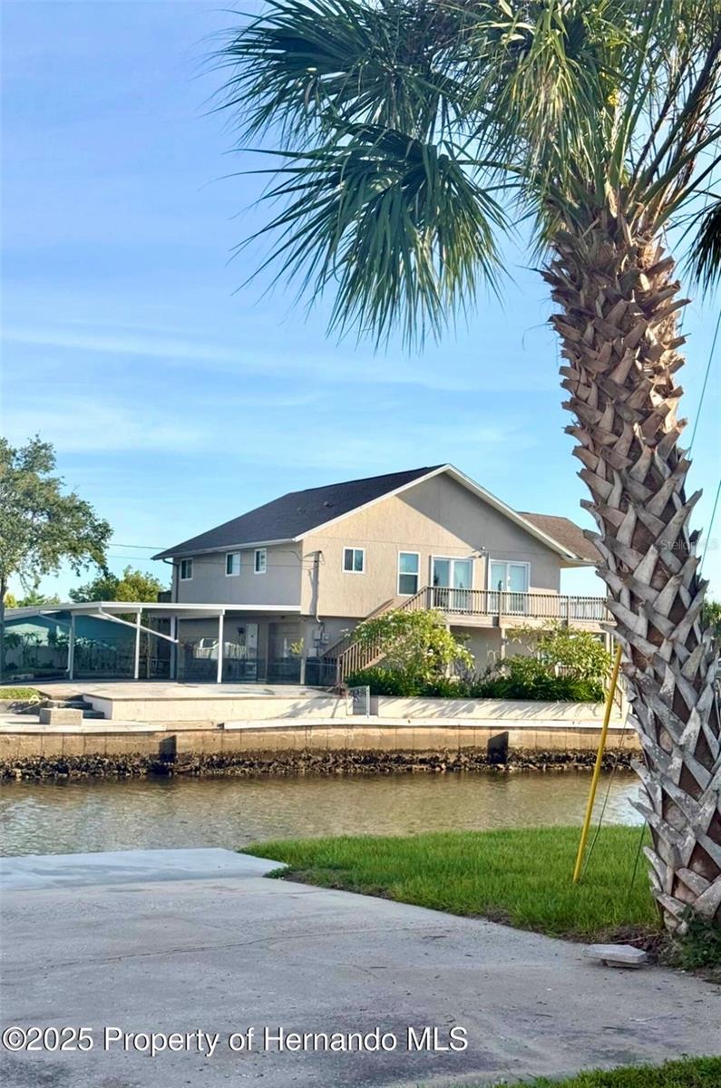 Welcome to your coastal escape in Hudson Beach Estates! This elevated 3-bedroom, 2-bath, 1296 sq.ft. 1-car gargae home is perfectly situated on a corner lot along a wide, deep canal, offering direct Gulf access and unobstructed views of the main channel. Whether you're seeking a full-time residence, seasonal retreat, or investment property, this gem checks all the boxes—no HOA, short-term rental-friendly, and golf cart accessible.
Inside, you'll love the bright, open floor plan, highlighted by cathedral ceilings and newer flooring. The home features updated windows, sliding doors and blinds throughout, adding comfort and efficiency. The spacious living area flows out to a generous deck, ideal for entertaining, relaxing, or watching incredible sunsets.
Recent upgrades include:
New roof (2018), New AC and ductwork (2024), Hot water heater (2019), Deck (2020)
Home features a vertical platform lift for easy access and wheelcahir accessibility.
Full retaining wall surrounding the property and 14-foot elevation
One-car garage with additional space to make your own
Bring your boat, kayak, or paddleboard—your backyard is the water! Just a short stroll or golf cart ride away are some of the area's top waterfront destinations. Conveniently located for commuting to Tampa (~45 mins), Clearwater (~1hr), and Orlando (~2hrs)
Hospital (~1 mile)
This move-in-ready home offers the perfect blend of lifestyle, location, and investment potential. Don't miss your chance to own a piece of Florida's waterfront paradise!