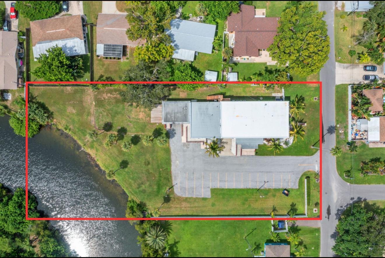Outstanding Lakefront Mixed-Use Property | Zoned General Office/Residential: An exceptional opportunity awaits with this lakefront property spanning 1.13 acres in unincorporated Pinellas County. Rarely does a parcel combine this level of residential comfort, business-ready flexibility, and income potential in one offering. Zoned General Office/Residential, the property allows short-term rentals and supports a wide array of professional uses, making it the ideal choice for a live–work environment, commercial investment, or private compound. The residence offers 5,160 sq. ft. of beautifully remodeled living space with 4 oversized bedrooms, 3 designer bathrooms, indoor laundry room, utility room (gym), storage rooms, and multiple gathering areas that make both everyday living and entertaining effortless. At it's center a modern kitchen and custom finishes strike the perfect balance of form and function. The home’s industrial-chic design with soaring ceilings, barn doors, and modern finishes creates a stylish and inviting environment throughout. Connected to the residence is an impressive 1,896 sq. ft. office/flex wing, featuring two oversized rooms measuring 29x20 and 31x38. This property was formerly used as a preparatory school and child care center, highlighting its adaptability and compliance with demanding operational standards. Together, the residence and office/flex areas provide a combined 7,056 heated square feet, offering unmatched versatility for both lifestyle and professional use. The property’s General Office/Residential zoning permits a wide variety of businesses including law offices, real estate offices, medical and dental practices, wellness and fitness centers, educational facilities, veterinary offices, government and administrative functions, creative studios, and other compatible professional services. Few properties provide this level of zoning flexibility combined with a turnkey residential component. Business owners will also value the commercial-grade fire sprinkler system, which brings the property into immediate compliance with fire-safety standards—an advantage for medical, educational, or high-traffic professional uses. Additional infrastructure includes an oversized 4-car garage, 16+ parking spaces with ADA access, high ceilings, and a remodel designed for both practicality and sophistication. Outdoors, the property offers a peaceful retreat on the banks of a scenic saltwater lake, home to Snook, Redfish, Bass, Tarpon, and abundant birdlife. There is ample room to add a pool or create customized outdoor venues to expand the property’s functionality even further. Within minutes, you’ll reach pristine Gulf beaches, Tampa, Downtown St. Petersburg, and Clearwater and quick access to shopping, dining, and entertainment. The property’s location in unincorporated Pinellas County offers another important advantage: the ability to operate short-term rentals. For investors, this opens the door to lucrative rental income. Combined with its residential and office/flex spaces, the property can be configured in countless ways to generate returns. This is more than just real estate—it’s a rare opportunity to live, work, invest, and thrive in one of Florida’s most desirable regions. With its flexible zoning, short-term rental eligibility, and turnkey infrastructure, this property is ready to bring any vision to life.