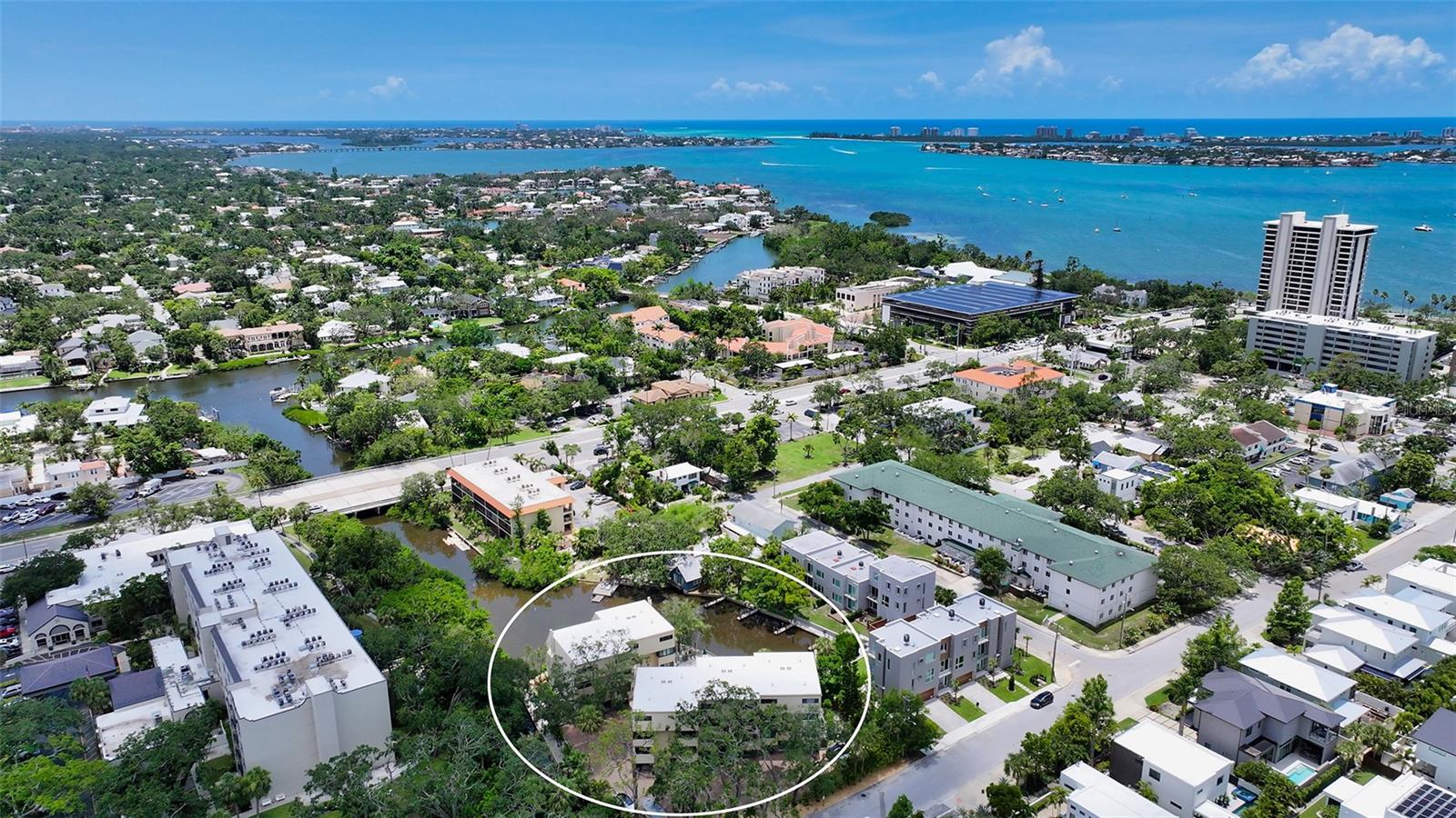 Live on the water in the heart of Downtown Sarasota. Tucked away in a beautifully shaded, WATERFRONT community along the Hudson Bayou, this UPDATED condo is the perfect blend of urban convenience and serene, coastal living. Located in Hudson Oaks, a hidden gem between historic Laurel Park and eclectic Burns Court, you’re just steps from Sarasota’s finest dining, shopping, entertainment, Selby Gardens, the Bayfront, and only a bike ride over the Ringling Bridge to Lido Key Beach and St. Armands Circle. Drenched in natural light, this spacious 2-bedroom, 2-bathroom, 2-balcony residence is designed for effortless indoor-outdoor living. The open-concept great room features hurricane-rated sliders that lead to a covered balcony with peaceful water and pool views. Plexiglass half-walls offer unobstructed sightlines of the Bayou. A wood-burning fireplace and large bar area make this an entertainer’s dream. The updated eat-in kitchen is both functional and stylish, with soft-close cabinetry, pull-out shelving, quartz countertops, subway tile backsplash, stainless steel appliances, pantry closet, and a breakfast bar for additional dining space. The primary suite features a private covered balcony, walk-in closet with custom built-ins, and a beautifully renovated ensuite featuring dual sinks, quartz counters, and a walk-in tiled shower with glass door. A generous second bedroom includes a cozy alcove, while the second bathroom is equally refined with quartz counters, vessel sink, and tiled walk-in shower. Additional features: updated electrical panel (2023), roof replaced (2020), large windows and hurricane-rated sliders (2017), in-unit laundry with Maytag washer/dryer & storage cabinetry, laminate plank flooring, recessed lighting, ceiling fans, and Hunter Douglas shades. Attached carport under building with an oversized 14’ x 8’ storage room, perfect for beach gear, bikes, and more. Hudson Oaks offers rare waterfront living downtown with boat docks, kayak launch, swimming pool, gas grill, and a pedestrian bridge to Laurel Park. Hudson Bayou is a protected waterway with small boat access to Sarasota Bay, making it perfect for kayaking, paddleboarding, or simply enjoying the views. Surround yourself with multi-million-dollar homes in one of Sarasota’s most sought-after neighborhoods, and experience the Florida lifestyle at its best – private, pet-friendly, and just moments from everything Downtown Sarasota and life on the Gulf Coast has to offer.