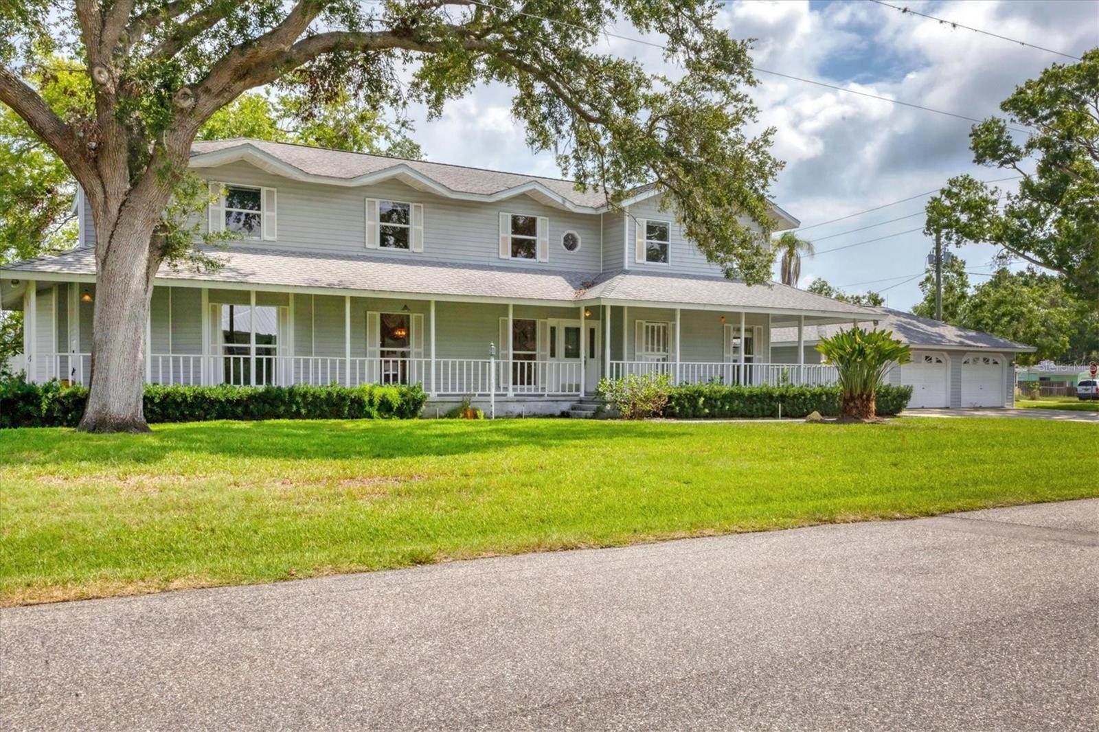 A rare canal-front opportunity in the heart of Palmetto! Gracefully poised on an oversized corner lot, this grand colonial presents an exceptional opportunity to own a canal-front home with direct Gulf and Bay access. Encompassing over 3,150 square feet of well-appointed living space, three bedrooms, 3.5 baths and a three-car garage with ample storage throughout. The home’s classic architecture is complemented by modern comforts, updated kitchen with granite countertops and overlooking serene canal views. The kitchen flows effortlessly into the spacious family room, where a natural fireplace adds ambiance. A formal living room and dining room offer refined spaces for entertaining, while a full bath on the first floor provides convenience for guests and poolside gatherings. Sunlight pours into the expansive sunroom, where walls of windows frame captivating views of the pool and canal. Go onto a generous deck, ideal for alfresco dining, lounging or simply enjoying the peaceful waterfront setting. Upstairs, the grand staircase opens to a versatile bonus room, ideal as a media lounge or home office. The primary suite is a retreat, complete with a built-in desk, spa-like en-suite bath featuring double vanities, a tub and an oversized walk-in shower. Two additional bedrooms—each with walk-in closets and custom built-ins—offer comfort and functionality. Positioned near historic downtown Palmetto and just moments from the Bradenton Yacht Club, Gulf beaches, Sarasota, St. Petersburg and Tampa, this property effortlessly blends coastal charm with urban accessibility. An extraordinary lifestyle awaits at 2002 8th Street W, where water, tranquility and location converge.