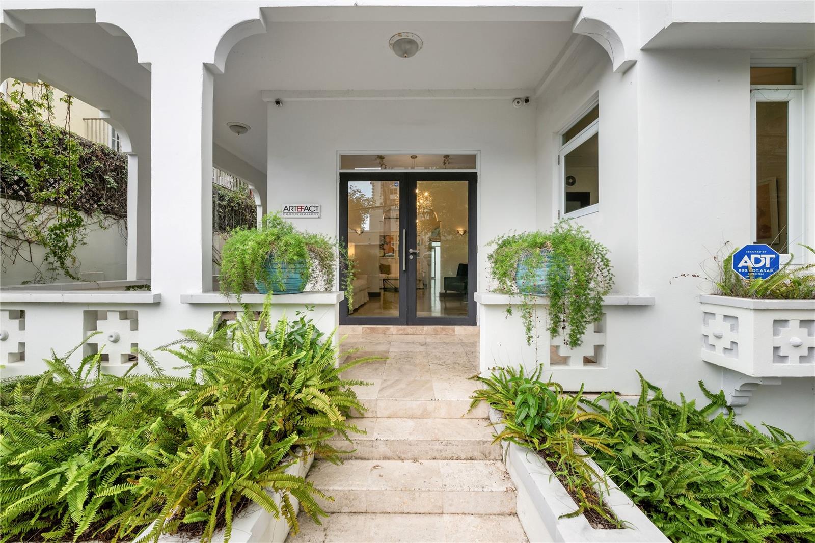 This reimagined 1940s Spanish Revival estate in Condado offers an exceptional blend of luxury, versatility, and location. Featuring four bedrooms, two full bathrooms and two half bathrooms in the primary home, and a detached guest house with one bedroom, one bathroom, and a full kitchen. This versatile property is set on a rare 450 square meter lot that includes a gated one-car garage and covered parking for up to four vehicles.
Boasting ten-foot ceilings throughout, travertine flooring, and two professional-grade kitchens, the home was meticulously renovated with fully updated electrical and plumbing systems, split-unit air conditioning systems, storm-rated windows and doors, on-demand water heating, security system throughout, and fiber optic internet. The expansive 1,900+ square foot rooftop retreat boasts a custom-built gazebo, Jacuzzi spa, and panoramic views of the Condado skyline, ideal for entertaining or relaxing. A tranquil courtyard with a Spanish-style fountain enhances the serene, resort-like ambiance.
Once the private residence of iconic poet and women’s rights pioneer Lola Rodríguez de Tió, this home carries a legacy of cultural distinction that enriches its timeless elegance and modern luxury, making it perfectly suited for elegant family living, multi-generational household, or boutique commercial use such as a guest house or Airbnb.
Ideally located walking distance from San Juan’s top schools, pristine beaches, upscale shopping, world-class dining, and major medical facilities, this estate offers an unmatched lifestyle for families or investors seeking a prime hospitality opportunity.
