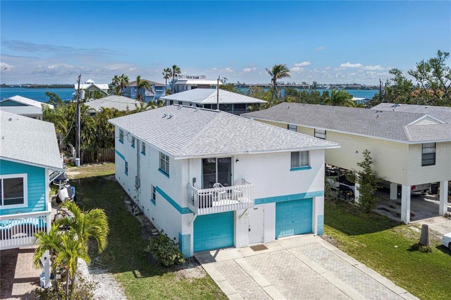 COASTAL BEACH LOCATION! This beauty sits between one block from the Bay and two blocks from the beach! This has been a one-family-owned home since it was built, enjoyed and loved by the entire family. Surrounded by beauty, sunny skies and a gorgeous beach JUST steps away from your front door! Featuring a four-car garage! Storage galore for your boats, golf carts, kayaks, cars, you name it! This is rare to find in this area. You have options galore! It is currently being used as a Duplex.  The setup is all upstairs as a two bedroom, two bathroom in the front and back. On each side, you have a private entrance and a two-car extra-large garage under both sides for a total of four extra-large garages. You can keep it this way, live on one side, rent the other, or rent both, or make it a single-family dream beach getaway. We still have better news here. The home stood strong from the hurricane, minor water came into the garages and that was an easy fix to deal with. No major damage here. The a/c units are only a few years old and the roof was replaced 2023. This home is priced to sell for this area that boasts MANY homes in the multi-millions. IT HAS UNLIMITED POTENTIAL. In addition, you are in the heart of the historic Cortez Beach Village, close to all dining options, shopping and the trolley is always ready to take you for a free stroll on this island. Take advantage today and schedule your private tour!