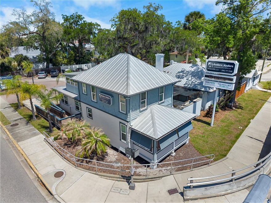 Look no further for one of the most visible and strategically positioned commercial properties in all of New Smyrna Beach. Ideally situated at the base of the South Causeway—providing direct access to the beachside—this property sits on a premier corner at one of the busiest intersections in the area, directly across from AdventHealth New Smyrna Beach. Spanning approximately 0.26 acres of prime real estate, the property boasts nearly 100 feet of frontage along State Road 44 and approximately 116 feet along Live Oak Street, ensuring exceptional exposure, accessibility, and continuous traffic flow from both locals and visitors.This unique offering includes two separate, beautifully restored buildings, completely renovated in 2018 with meticulous attention to detail. The structures blend historic charm with modern functionality, showcasing original hardwood floors, multiple private offices, and flexible interior layouts suited for a wide range of commercial uses.
In addition, the property features three fully leased units, delivering immediate and reliable income. In many cases, the existing rental revenue could substantially offset the mortgage, making this an outstanding opportunity for both investors and owner-users.
Zoned under one of the most flexible mixed-use designations in the area and located within the short-term rental district, the property offers exceptional versatility for a wide range of commercial, residential, or hybrid uses—both now and in the future. Between the two buildings lies a thoughtfully designed, covered outdoor gathering space—perfect for client entertainment or tenant use—complete with a custom natural gas fire feature, water fountain, and fire pit, creating a distinctive and inviting atmosphere. The property also benefits from a large parking area, including six dedicated on-site parking spaces, along with an additional six shared spaces with a neighboring Airbnb property—providing ample and flexible parking options in this high-demand location. With its unbeatable location, strong income potential, zoning flexibility, and exceptional character, this is a rare opportunity to own a landmark commercial asset in one of the most sought-after corridors in the area.