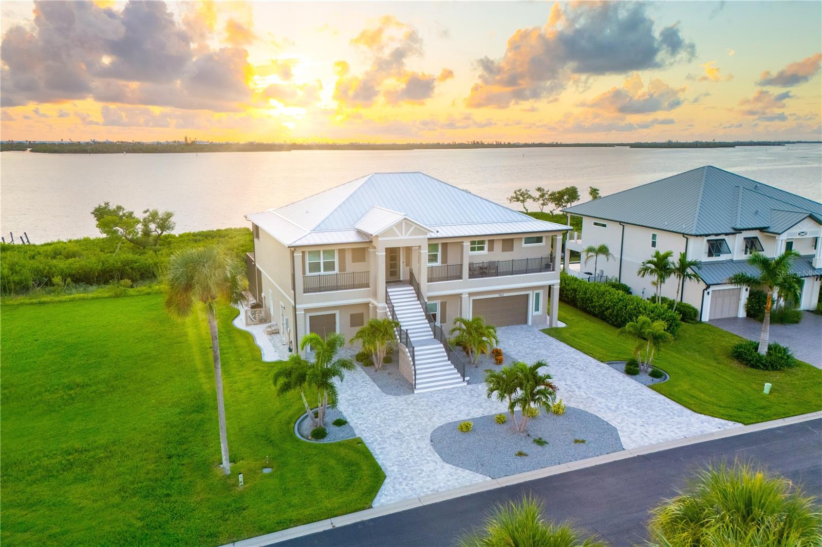 Located in Eagle Preserve Estates, a gated community perfectly positioned between Lemon Bay Golf Course and the beautiful waters of Lemon Bay and the Intracoastal Waterway, this exceptional waterfront home offers 111 feet of waterfront and is designed for effortless living, blending contemporary sophistication with breathtaking bayfront views. Just minutes from the charming island of Boca Grande, renowned for its quaint shops, pristine beaches, and exceptional dining, this residence offers an unparalleled Florida lifestyle.
Inside, luxury vinyl plank flooring flows throughout, enhancing the home’s sleek and modern appeal. Thoughtfully designed for both comfort and convenience, the home features a private Elevator, seamlessly connecting all levels, ensuring accessibility and ease of living. Remote-Controlled shades and Plantation Shutters create a refined ambiance, while integrated shades in the lanai doors allow for uninterrupted views of the tranquil bay. In lieu of a traditional open-air lanai, this residence features a thoughtfully enclosed waterside room—a refined and intentional design that elevates both comfort and livability. Framed by oversized picture windows, the space offers sweeping views of Lemon Bay, allowing you to fully immerse yourself in the natural beauty that surrounds you—all while remaining protected from heat, humidity, and seasonal pests. This peaceful retreat serves as a true extension of the home’s living space, merging the feel of outdoor living with the year-round comfort of a climate-controlled interior. Whether you're enjoying a quiet morning coffee or hosting evening guests, the room provides a front-row seat to the ever-changing landscape of coastal life—a daily luxury that redefines waterfront living. The contemporary chef’s kitchen provides style and function, featuring Quartz countertops, an Induction cooktop, a Microthermal Microwave oven, and a "Clear Cubes" Ice Maker—perfect for the true entertainer. A Silgranite Sink in both the kitchen and laundry room, along with a Column Refrigerator and freezer, adds to the sleek and refined aesthetic. Designed with privacy and comfort in mind, this home features three spacious bedrooms, each with its own private bath. The spacious primary bedroom and one guest suite open directly onto a bayfront lanai, creating a peaceful sanctuary where the beauty of the water becomes part of daily living.
On the lower level, functionality meets flexibility with an oversized garage, a separate golf cart bay, a workbench with overhead cabinetry, and two 50-amp service outlets—ideal for hobbies, tools, or extra storage. For the car enthusiast or collector, there's plenty of room with a 12-foot ceiling to accommodate a car lift, offering expanded capacity with ease. Catering to recreation and relaxation the 47-foot heated saltwater lap pool invites you to enjoy aerobics, exercise, or simply unwind while soaking in the bayfront scenery. A kayak-accessible walkway leads directly to Lemon Bay, offering the perfect launch point for waterfront adventures and fishing, or choose to extend a dock should you desire.
This extraordinary home offers luxury, comfort, and ease of living. With its prime location in Eagle Preserve Estates, thoughtful design, and amenities, it’s a rare opportunity to embrace the best of Southwest Florida’s waterfront lifestyle. (Golf Membership not required) Schedule your private showing today!