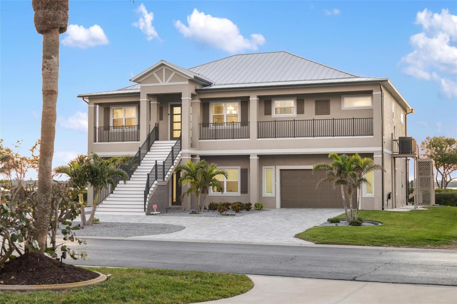 Located in Eagle Preserve Estates, a gated community perfectly positioned between Lemon Bay Golf Course and the beautiful waters of Lemon Bay and the Intracoastal Waterway, this exceptional waterfront home offers 111 feet of waterfront and is designed for effortless living, blending contemporary sophistication with breathtaking bayfront views. Just minutes from the charming island of Boca Grande, renowned for its quaint shops, pristine beaches, and exceptional dining, this residence offers an unparalleled Florida lifestyle.
Inside, luxury vinyl plank flooring flows throughout, enhancing the home’s sleek and modern appeal. Thoughtfully designed for both comfort and convenience, the home features a private Elevator, seamlessly connecting all levels, ensuring accessibility and ease of living. Remote-Controlled shades and Plantation Shutters create a refined ambiance, while integrated shades in the lanai doors allow for uninterrupted views of the tranquil bay. In lieu of a traditional open-air lanai, this residence features a thoughtfully enclosed waterside room—a refined and intentional design that elevates both comfort and livability. Framed by oversized picture windows, the space offers sweeping views of Lemon Bay, allowing you to fully immerse yourself in the natural beauty that surrounds you—all while remaining protected from heat, humidity, and seasonal pests. This peaceful retreat serves as a true extension of the home’s living space, merging the feel of outdoor living with the year-round comfort of a climate-controlled interior. Whether you're enjoying a quiet morning coffee or hosting evening guests, the room provides a front-row seat to the ever-changing landscape of coastal life—a daily luxury that redefines waterfront living. The contemporary chef’s kitchen provides style and function, featuring Quartz countertops, an Induction cooktop, a Microthermal Microwave oven, and a "Clear Cubes" Ice Maker—perfect for the true entertainer. A Silgranite Sink in both the kitchen and laundry room, along with a Column Refrigerator and freezer, adds to the sleek and refined aesthetic. Designed with privacy and comfort in mind, this home features three spacious bedrooms, each with its own private bath. The spacious primary bedroom and one guest suite open directly onto a bayfront lanai, creating a peaceful sanctuary where the beauty of the water becomes part of daily living.
On the lower level, functionality meets flexibility with an oversized garage, a separate golf cart bay, a workbench with overhead cabinetry, and two 50-amp service outlets—ideal for hobbies, tools, or extra storage. For the car enthusiast or collector, there's plenty of room with a 12-foot ceiling to accommodate a car lift, offering expanded capacity with ease. Catering to recreation and relaxation the 47-foot heated saltwater lap pool invites you to enjoy aerobics, exercise, or simply unwind while soaking in the bayfront scenery. A kayak-accessible walkway leads directly to Lemon Bay, offering the perfect launch point for waterfront adventures and fishing, or choose to extend a dock should you desire.
This extraordinary home offers luxury, comfort, and ease of living. With its prime location in Eagle Preserve Estates, thoughtful design, and amenities, it’s a rare opportunity to embrace the best of Southwest Florida’s waterfront lifestyle. (Golf Membership not required) Schedule your private showing today!