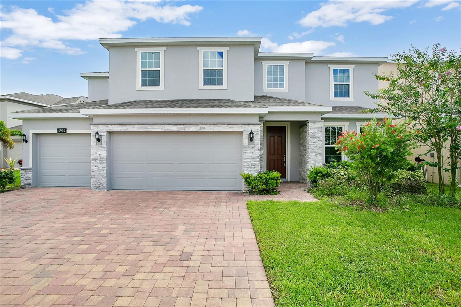Welcome to this beautiful 5-bedroom, 3.5-bath home built in 2021 and located in the desirable community of Hanover Lakes! Just minutes from Lake Nona and Medical City, this two-year-old home offers a stunning water view and a spacious, open-concept layout with soaring 20-foot ceilings in the foyer and living room. The gourmet kitchen features stainless steel appliances, a walk-in pantry, and an oversized quartz island that flows seamlessly into the main living area—ideal for entertaining. The first-floor primary suite offers privacy and comfort, while upstairs you'll find a large loft area and four generously sized bedrooms, each with walk-in closets. The second-floor laundry room adds everyday convenience. Enjoy peaceful water views from the covered rear lanai and direct access to the Alligator Chain of Lakes, perfect for boating and fishing. Community amenities include a resort-style pool, splash pad, and sundeck. Conveniently located near top attractions like Disney, Universal, and SeaWorld, with easy access to beaches and Downtown Orlando via nearby expressways. Don't miss this opportunity to own a waterfront home in a prime location!
