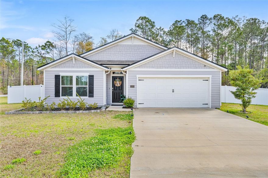 This beautifully maintained four bedroom, two bathroom Cali model sits on an oversized 1/3 acre corner lot surrounded by peaceful wooded privacy. The open floor plan creates an inviting atmosphere with spacious living areas that flow seamlessly for everyday living and entertaining. The home features luxury vinyl plank flooring in the main areas, stainless steel appliances, upgraded light fixtures, and a full irrigation sprinkler system.

The kitchen is thoughtfully designed with a beautiful backsplash, walk in pantry, and a large island with seating, making it perfect for gatherings or casual meals. A two car attached garage provides additional storage and convenience.

Step outside to enjoy the open backyard patio overlooking serene wooded views, offering a quiet place to relax and unwind. Ideally located with convenient access to I95, US1, beaches, parks, walking trails, golf courses, and nearby shopping and dining, this home offers the perfect blend of comfort, privacy, and accessibility.