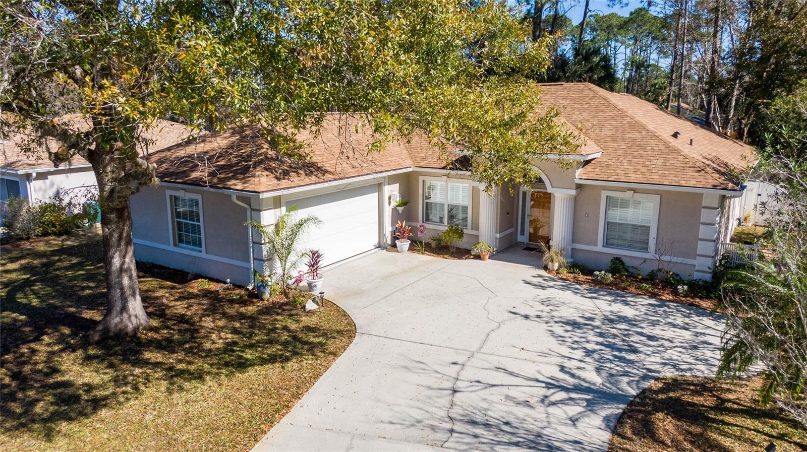 Welcome to 7 Windover Place, a beautifully refreshed 3-bedroom, 2-bath residence in the heart of Palm Coast. Offering 1,938 sq. ft. of thoughtfully designed living space, this home effortlessly combines modern upgrades with everyday comfort. Inside, the kitchen shines with brand-new appliances and elegant tile flooring, while luxury vinyl plank flooring in the bedrooms brings both warmth and durability. A convenient built-in desk creates the perfect workspace for remote professionals or students. Expansive quadruple sliders invite you outdoors to your private backyard retreat, where a generous screened-in porch is ideal for entertaining or simply relaxing. The oversized 525 sq. ft. side-entry garage provides abundant storage for vehicles, hobbies, or seasonal items. Recent updates—including a new roof (2023) and new water heater (2025)—give lasting peace of mind. Set beneath towering shade trees, the property remains naturally cool, while the brand-new sprinkler system keeps the fenced yard lush and vibrant—perfect for pets or play. All this, just minutes from Pine Lakes Golf Club, medical centers, shopping, dining, and a short drive to the pristine beaches of Palm Coast. This move-in-ready home truly has it all—schedule your private tour today!
