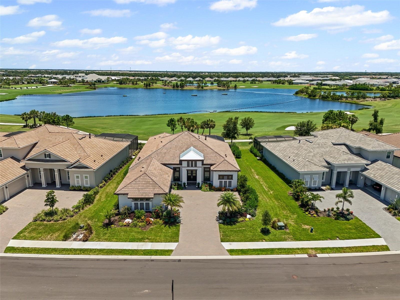 Your Dream Golf & Waterfront Oasis Awaits at Azario!
Whether you’re an avid golfer or simply appreciate unparalleled views and luxury living, this “unicorn” property is your once-in-a-lifetime opportunity! Nestled in the sought-after Esplanade at Azario Lakewood Ranch, this model-quality, West Indies-style Beacon home offers every upgrade imaginable — all in a no-longer-available floorplan!
Boasting 3 bedrooms, a versatile rear bonus room, and 3.5 baths across 3,668 sq. ft. of elegant living, this home is a true showstopper. A welcoming courtyard-style driveway, lush upgraded landscaping, and a three-car garage greet you upon arrival. Inside, engineered hardwood floors grace every room, while 12- to 13-foot tray ceilings and a thoughtfully designed open floor plan exude sophistication and grandeur.
Your chef’s kitchen shines with top-of-the-line GE Monogram stainless appliances, a double convection Wi-Fi-enabled wall oven, French door refrigerator, wine fridge, and an expansive island with two-tone shaker stacked cabinetry and glass-accented lighting. The bonus room is an entertainer's delight, complete with a custom platform desk, cable railings, and TV area.
Retreat to the primary suite, where a fixed glass window frames your spectacular water and golf course views. Three spacious California-closet systems add a touch of everyday luxury. Throughout the home, owners have thoughtfully added custom barn doors and fixed glass windows to maximize style and light — all part of their substantial monetary investment in upgrades.
And the lifestyle extends outdoors! The resort-style lanai features an oversized saltwater pool with a sun shelf, floating firepit, waterfall, LED lighting, and spa with infinity spillover — all fully automated for ease. The outdoor kitchen is a chef’s dream with a gas grill, pizza oven, refrigerated drawers, sink, hidden vent hood, and dedicated gas line for the firepit and seating area. The owners even framed out the new summer kitchen to provide much-needed wall space for an oversized outdoor TV!
Smart home automation includes Wi-Fi enabled shades, Sonos speakers (inside and out), lighting, thermostats, garage doors, and more. Plus, the 3-car garage is a hobbyist's dream with built-in deep shelving, golf valet, slat wall storage, and epoxy flooring.
With seven months of post-closing enhancements already completed, all you need to do is move in and embrace the Esplanade at Azario lifestyle — an exceptional, resort-style community offering an 18-hole championship golf course, pro shop, Bahama Bar, Venue, aqua driving range, 16 pickleball courts, 6 clay tennis courts, bocce, resort-style pool, spa, fitness center, fire pit area, and a Culinary Center with teaching kitchen — all behind a secure, gated entrance.
This is more than a home — it’s a lifestyle. Don’t wait to experience luxury, golf-front living at its finest. Schedule your tour today and start living the good life in Azario!