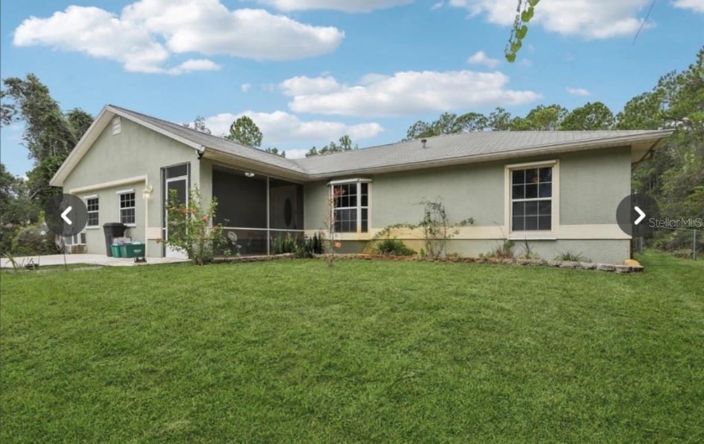Photo of 1594 Papaya Street, Bunnell, FL 32110 (MLS # O6422290)