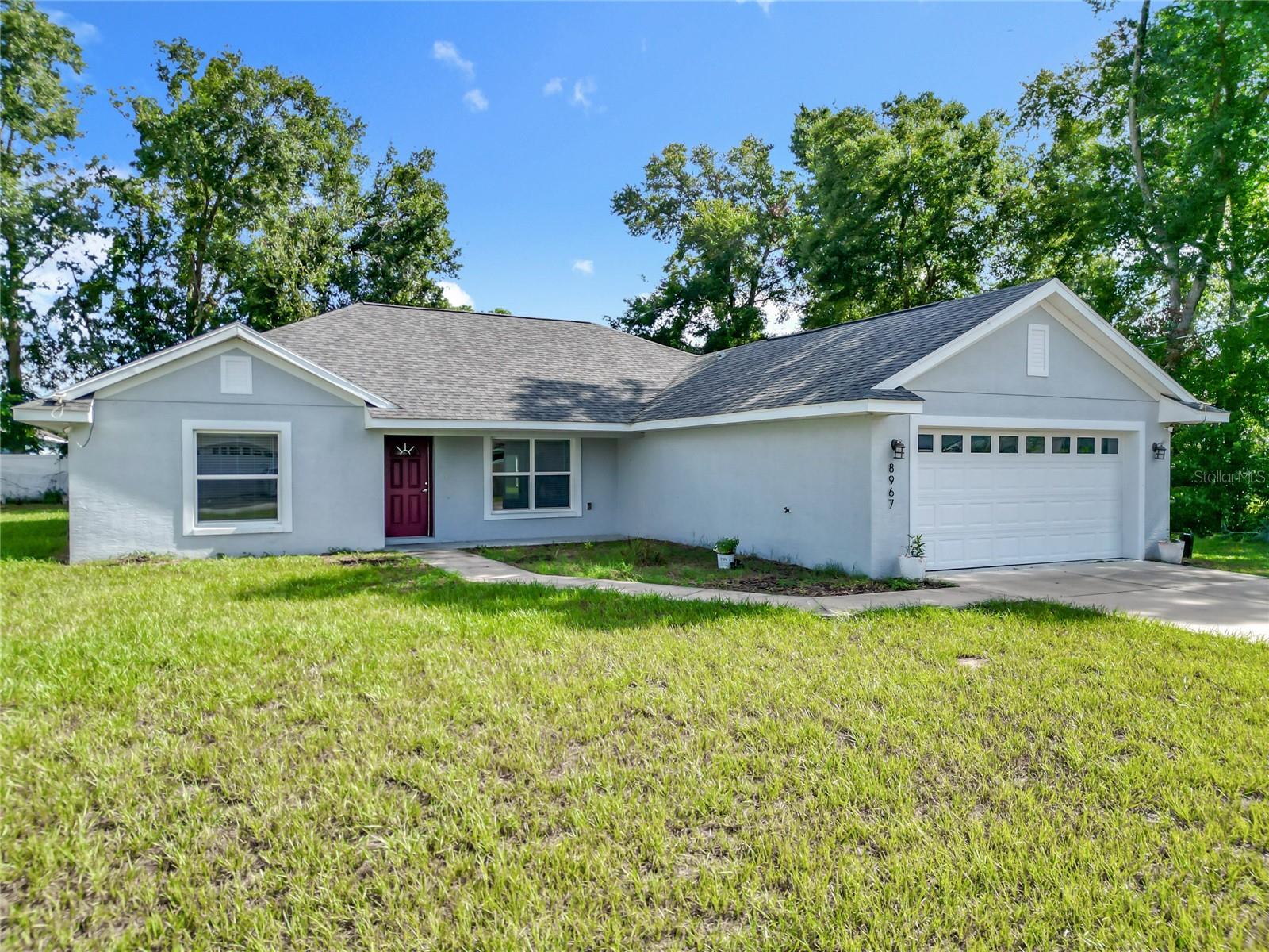 One or more photo(s) has been virtually staged. Knock Knock! Prepare to be Delighted! Seller relocating out of state. Now is the Perfect Time to make your Best Deal Ever on this Spacious & Modern, Move-In-Ready 3 Bedroom, 2 Bath Summerfield Home with Oversized 2-Car Garage! No HOA and Just 5 minutes from Mulberry Plaza, The Villages! This Modern Designer Home was Newly Constructed in 2020 and features an Open Split Floor Plan with Endless Features & Upgrades, including all Granite Countertops, Luxury Vinyl Flooring & Ceiling Fans throughout, Vaulted Ceilings, Gourmet Designer Kitchen with Bay Windows, Wood Cabinetry with Soft Touch Drawers, Stainless Steel Appliances, Granite Center Island Breakfast Bar, Granite Countertops & Large Pantry, Expansive Living Room, Formal Dining Room with French Patio Doors and Covered Concrete Outdoor Lanai Patio, Elegant Master Bedroom with Tray Ceilings and Dual Walk-In Closets, Luxurious Master En-Suite with Dual Sinks, Granite Countertop, Frameless Glass and Walk-In Tile Shower, Two Large Ultra-Comfortable Guest Bedrooms with Tray Ceilings and Large Closets, Guest Bathroom with Granite Countertop Sink, Tile Tub and Shower, Domestic Laundry Suite with Granite Countertop, Wet Sink and Wood Cabinetry. Ideal Community for growing families, active couples, individuals and business professionals desiring a Modern Home with Designer Features in a Peaceful Community. Close to Medical, Shopping and Restaurants! Just 10 minutes from The Villages, 15 minutes to Lake Weir & 30 minutes to Ocala. Call to Make Your Personal Showing Appointment & Get Ready to Move!
