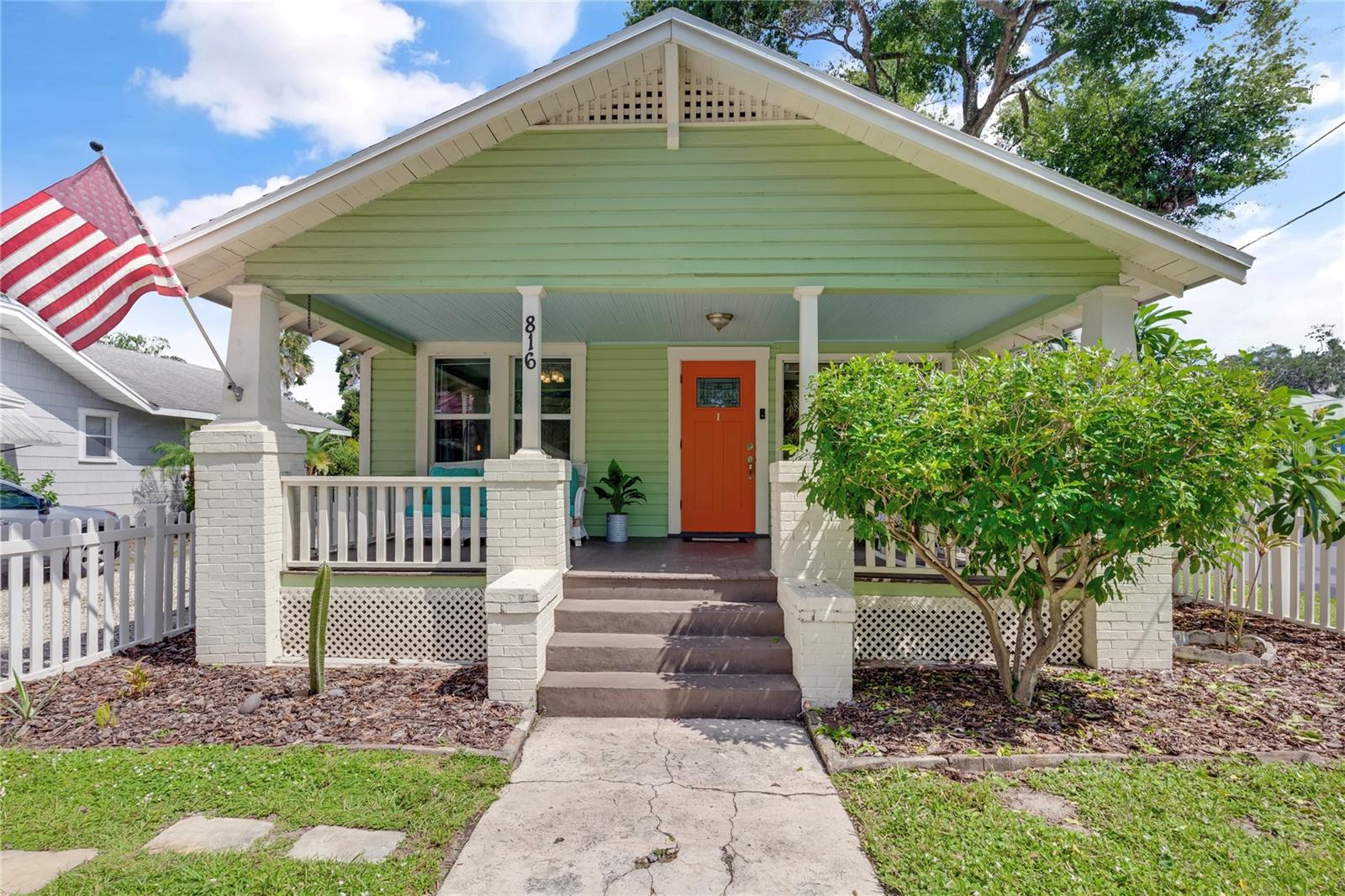 Seminole Heights ~ Well-kept & skillfully updated 1920's Bungalow built with pride & true craftmanship in the heart of Tampa Bay! Located on a peaceful dead-end street where neighbors are neighborly. NEW ROOF in 2023. A warm & cozy home decorated with a white picket fence & welcoming front porch to visit with friends, neighbors or just to enjoy the outside. Contemporary interior decor with updated paint colors. Spacious living areas with wood floors, wainscoting, decorative trim, & numerous windows allowing natural lighting to illuminate throughout. Enjoy entertaining this year especially at holidays with a spacious dining area complemented with a built-in butler's pantry. Perfect picture window to showcase this home & a perfect place for this year's Christmas tree! Home has been updated with modern day necessities like central a/c (new ductwork added in 2024), laundry facility, & new GARAGE door replaced in 2020. Upscale & well-laid out kitchen design for today's lifestyles that include raised panel cabinets, lazy susan, Kitchen-Aid built-in refrigerator with matching panels to blend with cabinets, SS DISHWASHER, GRANITE, marble tile backsplash, track lighting, & large off-set floor tile. Primary bedroom with 2 secondary bedrooms & 2 FULLY UPDATED BATHS making this home perfect for families & singles alike. Bedroom 2, could easily convert to office space, flex space, media room, gaming room, etc. Large fenced-in (double gated entry for Boat, RV, Toys) backyard with cabana that includes a large TV & firepit. Plenty of room to add a pool too! Just across the street from one of the original Publixs & within minutes of downtown Tampa, University of Tampa, 5-STAR restaurants, Curtis Hixon Hall, Bucs football stadium, Gandy boat ramp, Tampa Convention Center, Tampa Bay Lightening arena, museums, Channelside, interstates, International mall, AIRPORT, MacDill, Tampa Zoo, homestyle bakeries, Busch Gardens & much, much more! Location perfect for those who are love to experience it all! Call TODAY for your PRIVATE showing!