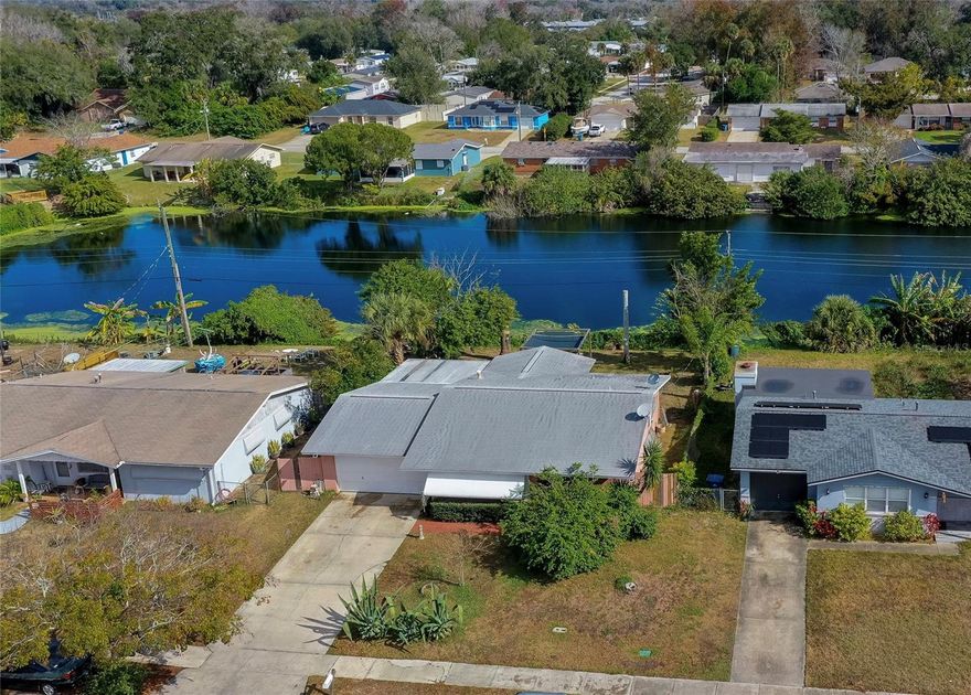 Welcome to this charming 2-bedroom, 1.5-bath home in the Beverly Hills community with direct lake views and a peaceful backyard setting. This well-maintained home offers a bright, comfortable layout that feels both practical and welcoming. The spacious living area is filled with natural light from large front windows and offers plenty of room for everyday living or entertaining. The adjacent dedicated dining area features sliding glass doors that provide a bright backdrop and easy access to the outdoor living space. The kitchen features rich wood cabinetry, generous counter space, ample storage, pantry access, and open sightlines to the living area for added convenience. The primary bedroom offers soft natural light, a cozy atmosphere, and access to a half bath. A second bedroom provides flexible space for guests, family, or a home office. An inviting enclosed porch adds valuable flex space for lounging, hobbies, or a secondary sitting area, with walls of windows that bring in abundant light and frame the backyard views. The spacious backyard features offers open lawn space, mature landscaping, and peaceful water views that create a tranquil outdoor setting for everyday enjoyment. With no HOA, the property offers added flexibility and fewer restrictions. Roof 2016, AC 2021, Water heater 2018. Conveniently located near major highways, dining, shopping, entertainment, the Intracoastal and of course, the World's Most Famous Beach. All information recorded in the MLS is intended to be accurate but cannot be guaranteed.