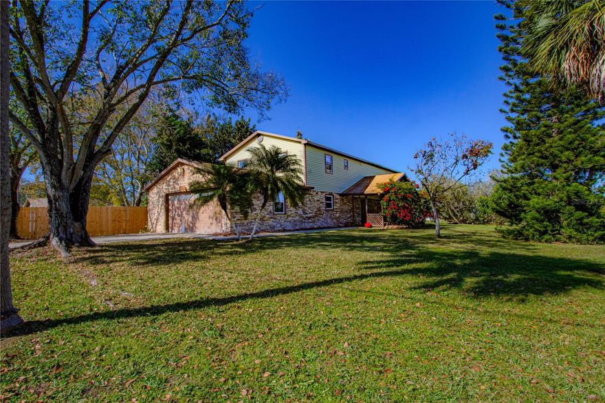 Discover your private sanctuary in the heart of St. Cloud. Welcome to a truly unique property that blends the peace of country living with the convenience of city access. Situated on a generous, fenced lot with mature landscaping, this custom 2-story home stands out with its charming stone façade, vinyl siding, and architectural character. Whether you have a boat, RV, or need space for a workshop, this property delivers with no HOA restrictions, a dedicated boat port/canopy, and a backyard utility sheds/workshops ready for your projects.

**Spacious Interiors with Character.**
Step inside to a grand living space featuring soaring vaulted ceilings and a dramatic open-rail staircase leading to a versatile loft—perfect for a home office or play area. The warm tile floors and custom terracotta accents create an inviting atmosphere, while the kitchen offers ample wood cabinetry, granite countertops, and stainless steel appliances. For those who love the outdoors, the expansive screened-in lanai provides the perfect spot for morning coffee or evening dining, overlooking the shaded, park-like backyard.

**Peace of Mind & Prime Location.**
This home has been meticulously maintained with major systems already addressed for you: a **roof replacement in 2018**, a brand new **AC compressor (2025)**, and the **septic system pumped just one year ago**.

You are perfectly positioned to enjoy the best of Central Florida:

* **Medical City & Lake Nona:** A short 20-minute drive puts you in the hub of world-class healthcare, dining, and shopping.
* **Theme Parks:** Enjoy a manageable 35-40 minute commute to Disney World and Orlando’s famous attractions.
* **Beaches:** Escape to the Space Coast! Melbourne and Cocoa Beach are approximately 50 minutes to the east for easy day trips.

---

### **Key Features at a Glance**

* **System Upgrades:** Roof (2018), AC Compressor (2025), Septic (Pumped ~1 year ago).
* **Exterior:** Unique stone & vinyl façade, large paved driveway, and walkways.
* **Outdoor Living:** Huge fenced backyard, screened lanai with ceiling fans, dedicated boat/RV canopy, and workshop/shed structures with playset.
* **Interior:** Vaulted ceilings, open loft layout, tile flooring throughout main areas, granite bathroom vanities.
* **Location:** St. Cloud, FL – High convenience to FL Turnpike, Orlando Int'l Airport, and Medical City.