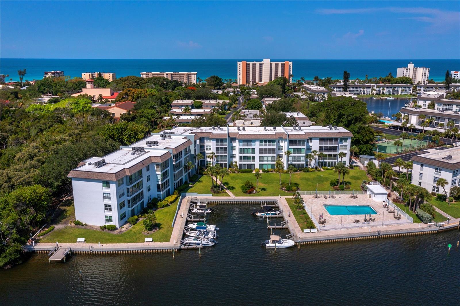It's all about the spectacular FULL BAY VIEWS in this tranquil and beautifully renovated island retreat located in the beach to bay community of Sutton Place. This 2 bedroom, 2 bath residence is a true coastal oasis all done up in seaside hues. The gorgeous, remodeled kitchen is open to the living/dining area across an expanse of granite that includes a custom made dining table with lots of storage underneath and seating all around! Porcelain tile flooring makes the journey from one room to another a seamless and beautiful transition. These smart owners have converted the lanai into finished square footage and it is the perfect spot to enjoy a morning coffee or an evening beverage while watching the fish jump or the birds fly by. They also upgraded to IMPACT RESISTANT SLIDING DOORS AND WINDOWS throughout. The Primary bedroom has this same gorgeous view and a renovated ensuite bath. The once walk-in closet was converted to a small office space, (which could easily be changed back) but it’s current use is rather genius. When guests are not in town, the 2nd bedroom is another tranquil space to enjoy. Did I mention this is a 2 pets friendly community?! Sutton Place also offers its own PRIVATE BEACH CLUB and includes an abundance of amenities including 2 pools, a clubhouse, and an onsite marina with slips for a nominal fee of only $300 per year. The community recently completed a number of updates including repainting, reroofing and passing the milestone inspection and securing a 10 year certification. This owner has paid for all of those upgrades in full. The unit is being offered furnished with exceptions. Here you will find a remarkable quality of laid-back island life but if you're ready for more, enjoy the multitude of restaurants, shopping and the cultural mecca of downtown Sarasota, all within a short drive away.
