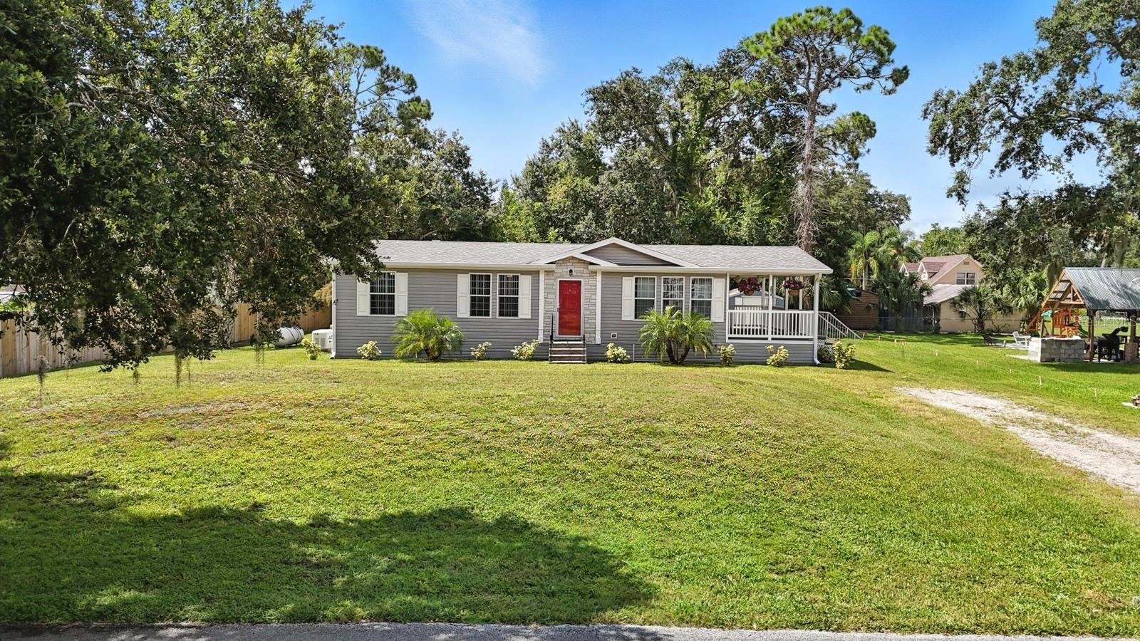 This is a modular home—not manufactured! Built to the same standards as site-built homes, this solid, well-constructed 3-bedroom, 2-bath home offers peace of mind, energy efficiency, and easy maintenance. Located on a quiet, high-and-dry street with no history of flooding and no HOA, you’re just minutes from the beach, the intracoastal, shops, restaurants, I-95, and SR-44—offering the perfect mix of privacy and convenience.
Lovingly maintained by its original owner, the home is completely move-in ready. Inside, you’ll find a clean, thoughtfully designed layout with updated bathroom flooring, new ceiling fans, a brand-new stove and microwave, and double-paned windows that help keep utility costs down and the interior quiet. The spacious living room flows into the kitchen, creating a welcoming space for both everyday living and entertaining.
Out front, enjoy the peaceful Trex deck-style farmer’s porch, complete with new outdoor ceiling fans—perfect for morning coffee or winding down in the evening. The oversized 15,000 sq ft lot offers plenty of room to spread out, and the home comes equipped with a whole-house Generac generator, a 10'x12' storage shed, and even a ride-on lawn mower to make yard care a breeze.
This modular gem combines quality construction, modern upgrades, and a location that’s hard to beat. Turnkey, well-kept, and worry-free—come see it for yourself!