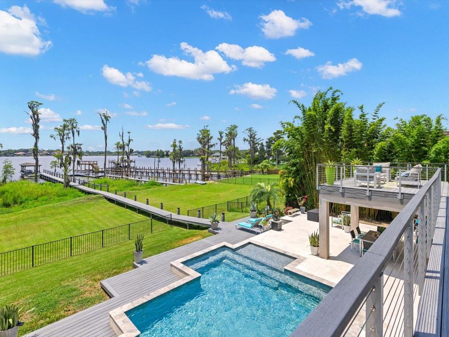 UPDATED PHOTOS - An elegant and stylish lakefront home awaits a new homeowner seeking ultimate form and function.  Welcome to 1941 Lake Roberts Landing Drive in Winter Garden - centrally located just minutes from the bustling shops and restaurants at Winter Garden Village while offering peak Florida lifestyle with a luxurious pool and direct access to Lake Roberts, a 113 acre Private freshwater lake.  Inside the home, you will be greeted with a completely renovated floorplan with Italian porcelain tile flooring throughout the main floor. A large kitchen with a gas stove, stainless appliances and an island are perfect for aspiring chefs along with the large custom cabinetry throughout with a view of the pool deck and lake. A primary bedroom with lake view with TWO walk-in closets is on the first floor with a 72" Kohler air micro-bubble tub. You can either take the sleek stairs to the second floor or head through the laundry room to the garage to take the elevator which takes you to the craft room or seventh bedroom.  On the second floor, there is another primary bedroom overlooking the pool and lake with a large walk-in closet as well as an exercise room or fourth bedroom. The loft/game room with bar and theater (currently used as a bedroom) offer more flexible space.  Two additional bedrooms and a full bathroom are tucked away for privacy offering an in-law suite. Once you step outside to the extended balcony you can soak in the captivating view of the lake and the private dock, perfect for a soiree or bird watchers. *You can also see DISNEY Fireworks across the Lake!* The dock is covered to house your weekend chariot, which includes a boat lift, ski docks, water and electricity.  A luxurious pool with commercial slide are wrapped by a large deck for any function or gathering. The home is equipped with MosquitoNix repellant misters throughout the backyard and a Kohler WHOLE HOME generator.  Good times are awaiting, call today to schedule your private showing. Creative Financing Available! 

<iframe width="853" height="480" src="https://my.matterport.com/show/?m=2Ek1LwFaxeP" frameborder="0" allowfullscreen allow="xr-spatial-tracking"></iframe>