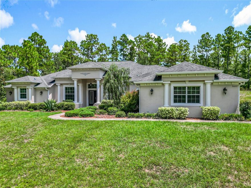 ***5.64 Acres*** Built in 2017, This beautiful 3Br/3Bth has over 3000 sq.ft. Split floor plan. NO HOA!! in PINE RIDGE FARMS community. Tile throughout except Brs...Gourmet KITCHENAID appliances in kitchen with Island. Granite countertops and walkin Pantry. Oven and Fireplace are (LP gas appliances). The Living room boasts beautiful high ceilings with crown molding and double tray detail. Enjoy the warmth of your fireplace (LP gas) on cooler evenings (remote controlled). Step out to the heated SALT water swimming pool and spa. Screened and a BRAND NEW PENTAIR CHLORINATOR smart pool pump system. Enjoy the outdoor summer kitchen on pavers with BBQ and refrigerator. The split floorpan offers 2 BRs with pocket door privacy for guest as it has a separate entrance with kitchenette in 3rd BR... Shower and tub. 50 amp RV hookup on the outside. TRANE 5 ton AC system. Plenty of room on expanded driveway. The Primary suite has a huge walk in closet...separate tub and shower and dual vanities. Access to the pool. Conveniently located close to restaurants...shopping and major roads. This home is on a quiet Cul-de-sac. Enjoy all that FLA has to offer. Come see it TODAY!!