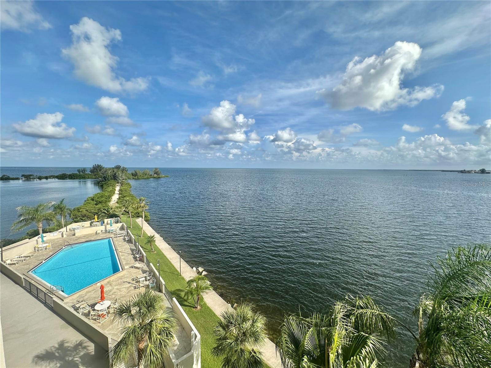"JAW DROPPING GULF OF AMERICA VIEWS, from this fifth floor furnished condo. Relax on the 22 ft private balcony with your favorite morning or evening beverage or meal watching the sparkling reflections of the Gulf and enjoying it's soothing breezes. Watch the dolphins play, the manatee float by, and all that Mother Nature has to offer on this "little island paradise. This 2 bedroom 2 bath condo features additional bonus room area with pull out sofa that can be used as dining room, office, den or maybe additional guests sleeping area. Upgraded Kitchen features newer self close cabinetry and granite counter tops. Dining has large glass top table with 8 chairs. Condo is offered furnished with all the appliances including washer and dryer. Two 8 foot wide sliding glass doors offer beautiful water views from the living room.dining area,kitchen,and master suite. This quiet island community is surroundd by water and boasts Gulf front heated swimming pool , tennis & pickleball courts, private beach, picnic area, nature's trail and 24 hour guards for your upmost security. This is all located in quaint & quiet Hudson Beach close to multiple area parks, SunWest Aqua Park,beaches, golf courses, and restaurants. Easy commute to all that the Tampa Bay and St Pete/Clearwater areas have to offer both day and night. This condo is offered rent for a month or more and rate may vary depending on the time of year and length of stay. . Call today!