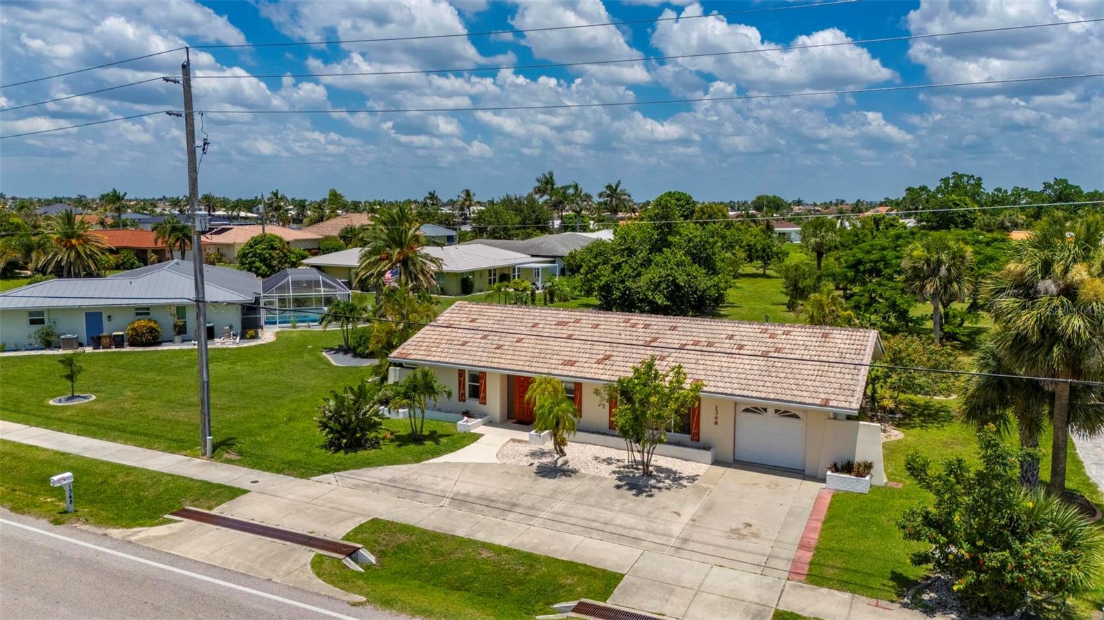 Welcome to this beautifully furnished 2-bedroom, 2-bathroom home located in the heart of Punta Gorda. This spacious and well-maintained residence offers a blend of comfort, functionality, and Florida charm—perfect for full-time living or a seasonal retreat. Inside, you’ll find a bright and open layout featuring a large living room and dining area that flows into an enclosed Florida room—ideal for lounging, entertaining, or enjoying your morning coffee.
The kitchen is generously sized, offering abundant cabinetry, a built-in pantry, and ample counter space for meal preparation. Both bedrooms are oversized with large closets, providing plenty of storage. Each bathroom is spacious and thoughtfully designed, complete with windows for natural light, plenty of cabinetry, and convenient layouts.
The rear lanai wraps around to the side of the home near the primary suite, creating a serene outdoor living space that’s perfect for relaxing or dining alfresco. Additional features include a durable tile roof, newer windows, a complete HVAC system installed in 2018, and a beautifully landscaped yard. The circular driveway offers great curb appeal and easy access, while a rear outdoor patio—accessible through the garage—adds another great space for gatherings or enjoying the Florida sunshine.
Offered furnished, this home is truly move-in ready. Located just minutes from elite golf courses, fine dining, shopping, entertainment, fishing piers, and the breathtaking blue waters of Florida’s Gulf Coast beaches—this is Florida living at its finest.