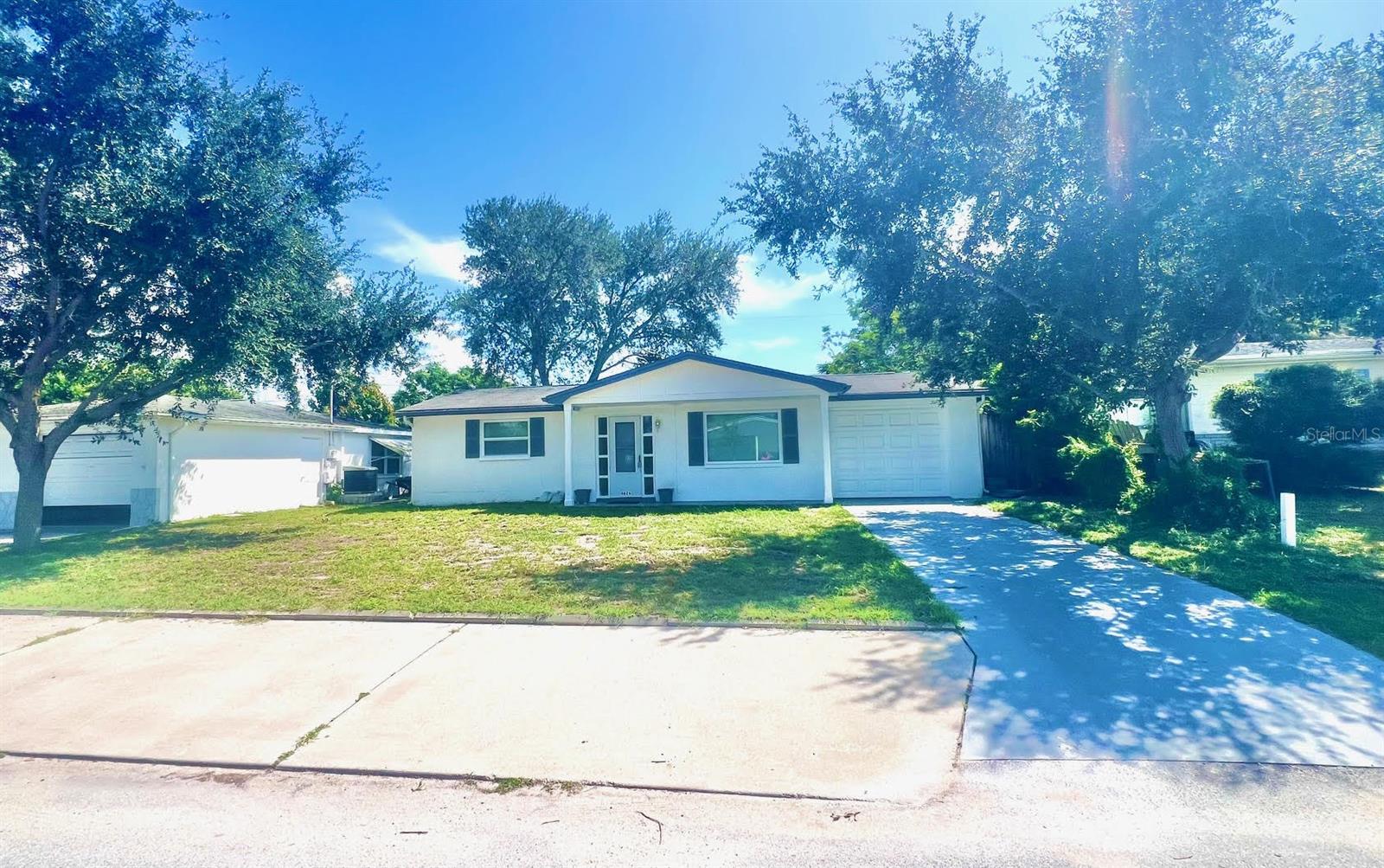 This is the one for you! Highly Sought after location at ORANGEWOOD VILLAGE of Holiday Florida that puts you near all you need and want to immerse in the wonderful Florida Lifestyle. Add to your short list now. We welcome you to a Single Family 1 Level Block Home with many cool features and upgrades. These include: Long Driveway, Tile Floors throughout, Updated Bathroom, 1 Car Garage, Front Covered Porch, 2 Bedrooms, Screen Door, Florida Room, Fenced-In Yard, Extra Parking in front of the home, Rear Covered Large Pergola with electrical & lighting, Blinds on the windows, Septic System to save you money, and more. **Home offered with Water, Trash Pickup, Sewer & Lawn Care** Plus Washer & Dryer Included for you. Available now and requirements include a completed digital application at https://apply.link/F12lkB0 with the following documents emailed for consideration: Driver's license, 2 months of bank statements, and 2 months of pay stubs. One small pet dog will be considered with landlord pre-approval (breed, weight to 35 pounds, and pictures required). A non-refundable pet fee of $250 for the pet and a refundable pet deposit of $250 are required. Anyone aged 18 or above must apply for the background check, includes a credit report, past evictions report, and employment or income verification for sufficient verifiable personal income, previous landlord references, and background screening. The owner advises against applying if you have credit scores below 650, have ever been evicted, or have a poor rental history. You may submit a letter of explanation if needed. Proof of renter’s insurance is required along with the first month's rent, last month's rent, and a security deposit. Enjoy all Florida has to offer and the Property is near all shopping, restaurants, Beaches, DT Tarpon Springs, Sponge Docks, Trinity, Places of Worship, Schools, Sams Club, Hospitals, and 30 to 45 minutes from St Petersburg, Tampa with all they have to offer. Call now to see and Lease before it is gone.