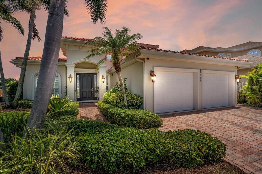 Welcome to your waterfront oasis! This immaculate home is the epitome of casual elegance. With its continuously updated features and stunning waterfront location, this property is a true gem.
As you step inside, you'll be greeted by the spacious living area adorned with 10-foot ceilings and crown molding, creating an atmosphere of grandeur. The impact-rated windows and doors allow natural light to fill the space while providing peace of mind and energy efficiency.  The gas fireplace adds warmth and ambiance to the indoor environment.
The master suite, conveniently located on the ground floor, offers a tranquil retreat with a large ensuite bath. Pamper yourself in the master bath featuring a Pearl jetted tub, capable of holding 150 gallons of soothing water.
This home is designed for entertainment and relaxation. Step outside to discover a heated saltwater pool, perfect for year-round enjoyment. Unwind in the outdoor shower or indulge in the luxury of the infrared sauna. A covered lanai provides refuge from the sun, or you may choose to soak up the sun on the pavered patio area.  There is access from the outside to a half-bath for convenience when enjoying the pool or outdoor activities.  There is an additional half-bath downstairs to assure convenience and comfort for your guests.
For the avid boater, this property is a dream come true. With its own dock and a 13,000 lb boat lift, you'll have easy access to the wide canal, offering mesmerizing Intracoastal Waterway views. Cruise to the Gulf of Mexico with ease and explore the warm Gulf waters.
Inside, the custom kitchen is a chef's delight, boasting solid wood cabinets, granite countertops, and top-of-the-line appliances. A gas cooktop is a rare find and perfect for the home chef. There’s an informal dining space just off the kitchen allowing casual meals with views of the pool and waterway. The formal dining room is a showstopper with a 16-foot coffered ceiling and indirect lighting, creating an intimate and luxurious dining experience.  Also, on the ground level you will find a great place to work in the formal office, with custom shelving and hardwood floors.  The office could be used as a 4th bedroom if needed as it has a large closet.
Upstairs you will find a serene retreat with two bedrooms, a full bath, a sitting area and balcony. 
Situated on a dead-end street with underground utilities, this waterfront neighborhood offers a peaceful and serene environment. The newer seawall ensures the integrity of the property, while the short distance to the beach provides endless opportunities for leisurely strolls along the shoreline.
In summary, this waterfront home is a rare find, combining luxurious amenities with a breathtaking location. From the heated saltwater pool and dock to the master suite on the ground floor and the gas appliances in the custom kitchen, every aspect of this property exudes elegance and functionality. Don't miss the opportunity to own this slice of paradise – it's truly a beach paradise!