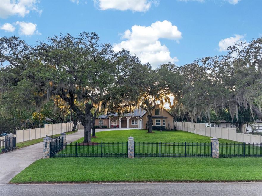 Just in time for the summer, the private oasis you've been waiting for is here! Escape the constraints of cookie-cutter neighborhoods with this exceptional CUSTOM-BUILT PRIVATE ESTATE at 2110 Corbett Rd, perfectly situated on a secluded 0.7-ACRE lot with NO HOA or CDD fees. Far exceeding builder-grade standards, this residence is constructed with SOLID CONCRETE WALLS for superior structural integrity, energy efficiency, and storm resilience. No staircase cracks here!  The interior radiates sophisticated luxury, featuring POLISHED TRAVERTINE FLOORS, hardwood accents, high-end plantation shutters, and professionally installed CUSTOM CLOSET SYSTEMS THROUGHOUT. At the heart of the home, the CHEF'S KITCHEN showcases exotic granite countertops, espresso real-wood soft-close cabinetry, and newer high-end stainless steel appliances.
The highly flexible layout functions as a 4-bedroom plus an office or a 5-bedroom, including multiple en-suite options rarely found in this style. The primary suite serves as a sanctuary with stone-enhanced showers and a private retreat feel, now upgraded with an in-line master bathroom exhaust fan for superior comfort. Guests or multigenerational families will appreciate the LARGE UPSTAIRS BONUS SUITE, which features its own full bathroom.
OUTDOOR LIVING RIVALS A WORLD-CLASS RESORT, centered around an automated saltwater pool equipped with propane fire bowls, waterfalls, and a pool heater.  Pool maintenance is a breeze thanks to the in-floor pool cleaners and a dedicated steel outbuilding that houses the pool and water treatment equipment. The lushly landscaped grounds, featuring mature oaks and palms, are fully irrigated and secured by an 8-foot perimeter fence with an automated aluminum front gate as you enter the property.
Engineered for peak performance, the home boasts a PAID-OFF SOLAR SYSTEM yielding average electric bills of nearly $0, SPRAY FOAM ATTIC INSULATION, and TWO HIGHLY EFFICIENT TRANE HVAC systems with REME HALO AIR PURIFICATION. A WHOLE-HOUSE WATER TREATMENT SYSTEM provides iron and sulfur eradication with UV disinfection. Further peace of mind comes from the NEWER ROOF (August 2023) with HAIL-RESISTANT SHINGLES and a transferable Golden Pledge Warranty, as well as NEW 7" SEAMLESS GUTTERS.  Complete with an OVERSIZED 3-CAR GARAGE featuring a custom workspace, integrated WHOLE-HOME AUDIO, and high-speed CAD wiring, this estate offers the ultimate blend of freedom, durability, and luxury.  CALL TODAY TO SCHEDULE A PRIVATE TOUR.