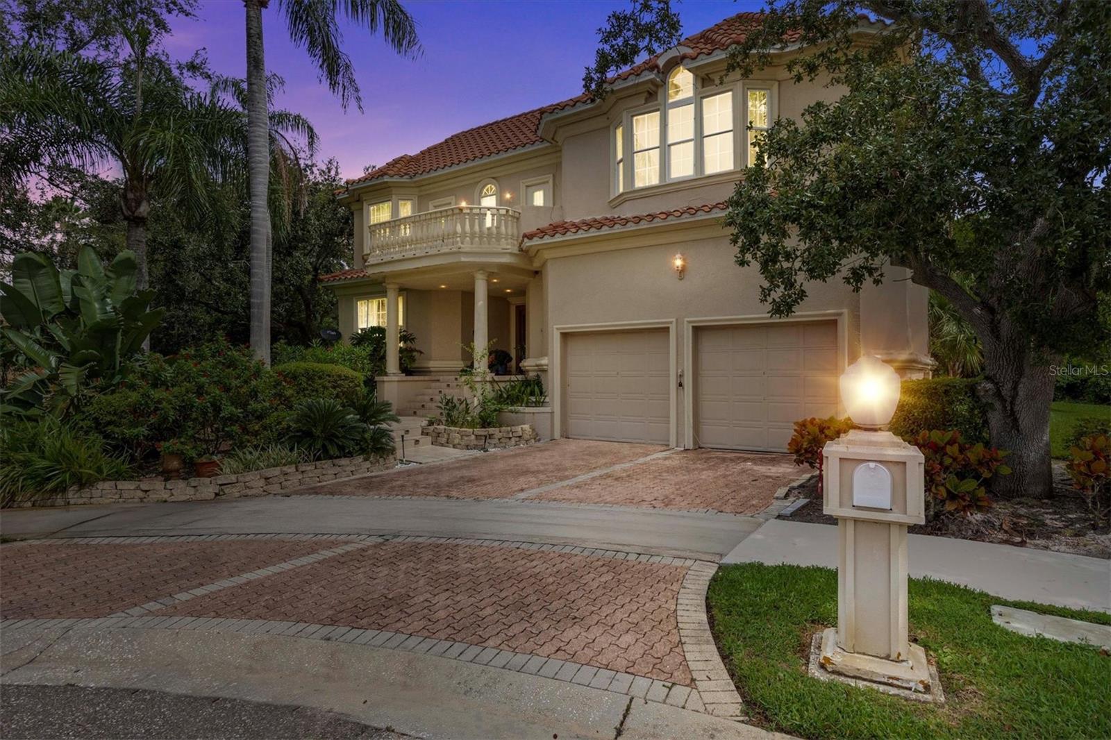 Beautifully updated 4-bedroom, 4-bath home in the guard-gated community of Andalucia. Set on a private cul-de-sac with nearly one-third of an acre, this modern coastal retreat showcases a unique design with soaring ceilings, open living spaces, a granite kitchen with upgraded appliances, renovated baths, and laminate flooring in all bedrooms. A cozy wood-burning fireplace adds warmth, while the screened pool and spa patio—complete with a pool heater—creates the ultimate year-round outdoor retreat. The property also features mature fruit trees, including mango and star fruit, bringing a touch of tropical charm right to your backyard. Residents enjoy resort-style amenities including a clubhouse, pool, tennis courts, playground, and a nearby private marina—just minutes from dining, shopping, and Tampa Bay attractions.