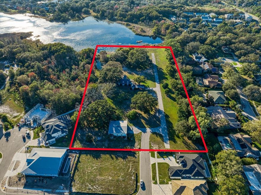 Embrace a once-in-a-lifetime opportunity at 2850 Sunstream Lane, one of the last and only large parcels of land available in one of the Tampa Bay area's best locations. This is not just a property; it's a canvas for your dreams. Nestled in a private, secluded lakefront location, these 6 acres provide an unparalleled opportunity for the construction of your dream home or present the perfect canvas for a thoughtful development project. The possibilities are endless, surrounded by the natural beauty of mature trees and the tranquility of Lake Chautauqua.

This property stands as a testament to rarity, being one of the final expansive lots in this coveted locale. The land, with a rich past as a flourishing orange grove, was part of a larger parcel that was thoughtfully subdivided into two premier subdivisions by the current owner. Now, in a momentous decision after generations in the family, the owner has chosen to release the last portion of this remarkable property, reserving the best for last.

This 6-acre parcel presents endless possibilities, offering the flexibility to be subdivided by a developer into a distinctive community or to serve as a canvas for building your new custom home overlooking the pristine Lake Chautauqua. Ideal for those needing to move swiftly, this property provides the unique option to construct a dream home on the water, adjacent to the existing residence.

Nestled in a secluded, private location, this property is a sanctuary awaiting your vision for a dream home or a developer's grand design. The updated mother-in-law suite adds versatility and comfort to the property, catering to both immediate needs and long-term plans.

Imagine waking up to serene lake views, surrounded by the tranquility of nature, all within easy reach of Clearwater's amenities, shopping, dining, and the Gulf Coast beaches. Top-rated schools and parks enhance the appeal of this exceptional property, making it an ideal haven for families, developers, or anyone seeking a unique slice of Pinellas County paradise.

Don't let this rare opportunity slip away! Schedule a showing today and unlock the potential that awaits at 2850 Sunstream Lane – where the best is truly saved for last!