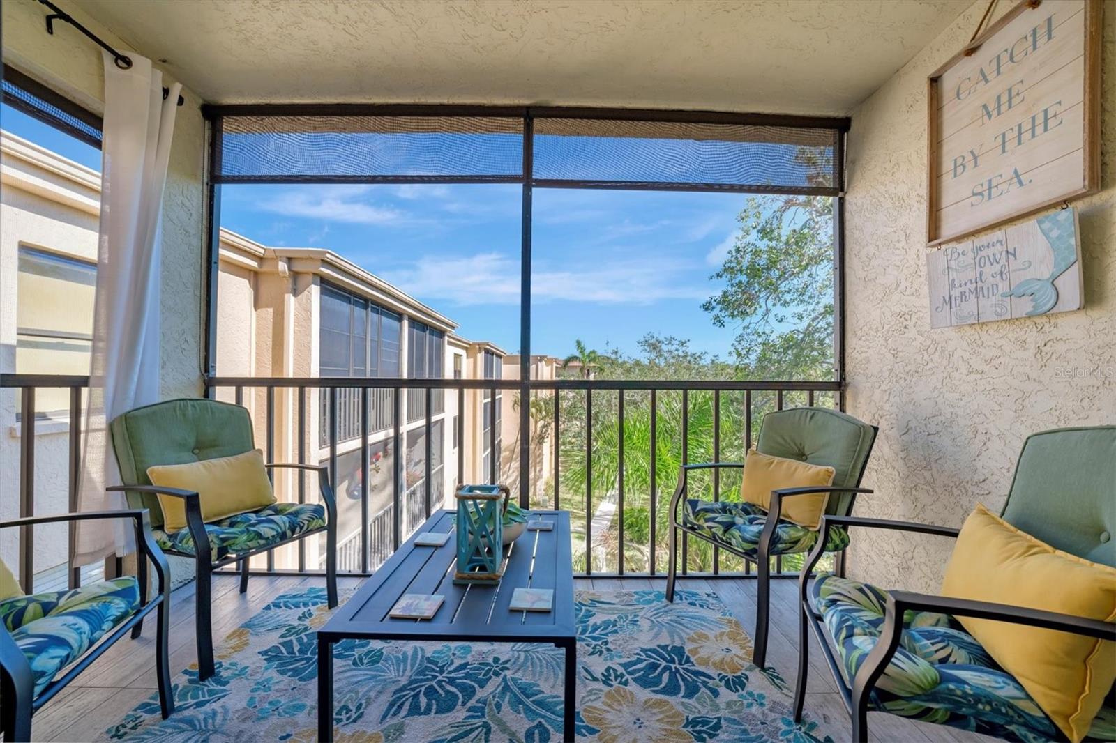 This beautifully renovated, turn-key furnished condo is a hidden oasis in the heart of Bradenton, with location as a standout feature. It offers easy access to Sarasota, Anna Maria Island, Gulf beaches, Bradenton’s keys, I-75, and downtown. This spacious 1-bedroom, 1.5-bath home, just under 1,000 square feet, is filled with high-end upgrades and comes completely furnished, including all Coastal décor, linens, and kitchenware—making it truly move-in ready. Quality tile plank flooring flows throughout, enhancing the clean, modern design. The extended kitchen is a showstopper, featuring an expansive quartz-topped island that blends style and function—perfect for meal prep, casual dining, or entertaining. Additional upgrades include a designer backsplash, soft-close drawers, raised soffits, and stainless steel appliances, offering both elegance and practicality. Stylish plantation shutters on the front and back windows, along with center-opening textured vertical blinds, add to the long list of extras. Upgraded lighting, outlets, and fans elevate the contemporary ambiance, while a front-door sliding screen allows for refreshing cross breezes. This top-floor unit with no neighbors above enjoys peaceful living with an abundance of natural light and serene water views, accompanied by the soothing sounds of a fountain. The lanai, finished with matching wood plank tile, overlooks lush landscaping, creating a peaceful retreat. Situated in Woodpark at DeSoto Square, a gated 55+ community, residents can enjoy amenities like a heated pool, spa, and scenic walking paths around the ponds. The building is pet-friendly and includes designated parking plus a storage space for beach gear. With its unbeatable location and tasteful Coastal-inspired design, this home is the ideal Florida getaway, close to Sarasota’s cultural offerings, Bradenton’s Riverwalk, and Tampa’s vibrant attractions.
