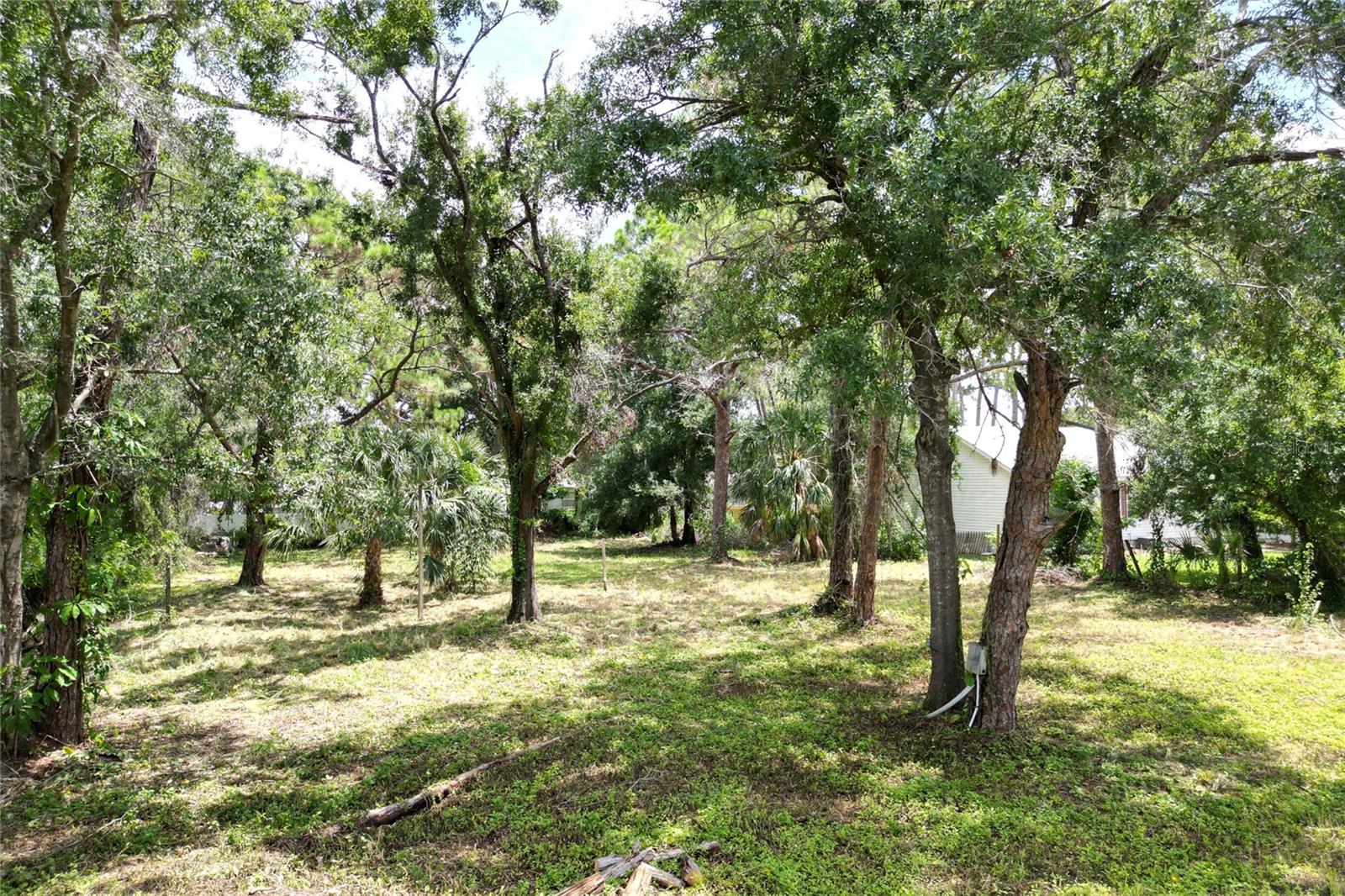 Rare Oversized Residential Lot Adjacent to Lime Lake Park – North Sarasota. Discover a unique opportunity to own a generously sized residential lot in North Sarasota, tucked away on a quiet street and bordered by the natural beauty of Lime Lake Park. This mostly cleared parcel features a scattering of mature trees, level terrain, and convenient access via 21st Street. With nearly the entire western boundary backing directly onto Lime Lake Park, you’ll enjoy exceptional privacy and a scenic buffer from nearby development. Ideal for both investors and those looking to build a custom home in a peaceful neighborhood, this lot offers versatility and value in one of Sarasota’s up-and-coming areas. The lot to the South is being sold separately if interested in doubling the size of your property. Please note: This parcel was recently subdivided from a larger 0.62-acre lot and may not yet be accurately reflected on County maps. Access is provided by a 20-foot easement along the eastern property line. For a visual representation of how this lot could be laid out after development, take a look at the property immediately to the East (2425 21 St St) and the property directly across the street (2410 21 St St). Both were divided in a similar fashion.