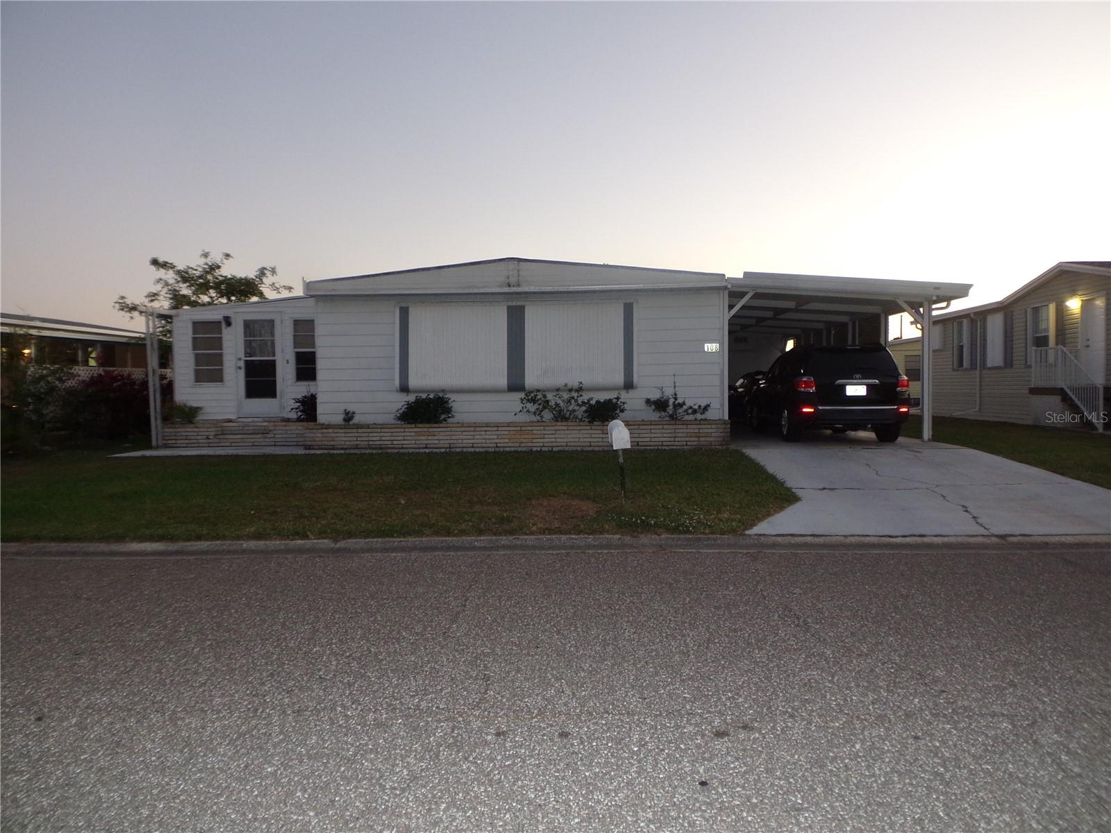 Welcome to the Coveted Community of Casa Loma, one of the few LAND-OWNED Mobile Home Parks with NO AGE RESTRICTIONS in Manatee County. There's no place Like Home...This Gorgeous 1976 Ridgewood Doublewide Home is move in ready and sits on a nice lot! This Beautiful Home has been completely Updated and includes 2 Bedrooms 2 Baths with a large carport that will accommodate 2 cars and includes a large shed under roof with washer/dryer hookups. There are Sliding Glass Doors leading to a Large Bonus Room that can be used as a 3rd Bedroom, Office or Den if necessary. What a Lovely White Kitchen with a Cute Breakfast Bar, Nice Newer Black Countertops accented by White Subway Tile Backsplash, A Pantry, Extra storage Closet and Loaded with Cabinetry. This Home Features Open Concept living with a Large Living Room/Dining Room Combo with Gorgeous Lakeshore Pecan Wood laminate flooring throughout for easy care cleaning! Includes newer subfloors & Upgraded Baseboards as well. Also Includes Built-In Hutch/Cabinetry in the Dining Area and newer Beige Ceramic tile in the Kitchen and both bathrooms. The A/C, Roof and Hot Water Heater are in good condition. This Home has Fresh Neutral paint & upgraded baseboards throughout along with new blinds. Nice Land owned Lot on a quiet street near the back of the subdivision. There is a Large Owner's Suite on the Right side of the home with a Large Walk-in Closet and an En-suite Bath with Walk-in Shower & Owner's Closet! This home is being offered Furnished for your convenience. What a Nice place to call home with Low Fees of $75 per month to maintain the Pool, Clubhouse, Lake and Common grounds. Call today for your private showing! This one is a Keeper!!! Friendly neighbors with greet you and join in the fun at the Large Clubhouse with a Gorgeous Pool overlooking a Beautiful Pond with Endless Sunsets. This is one you don't want to miss!