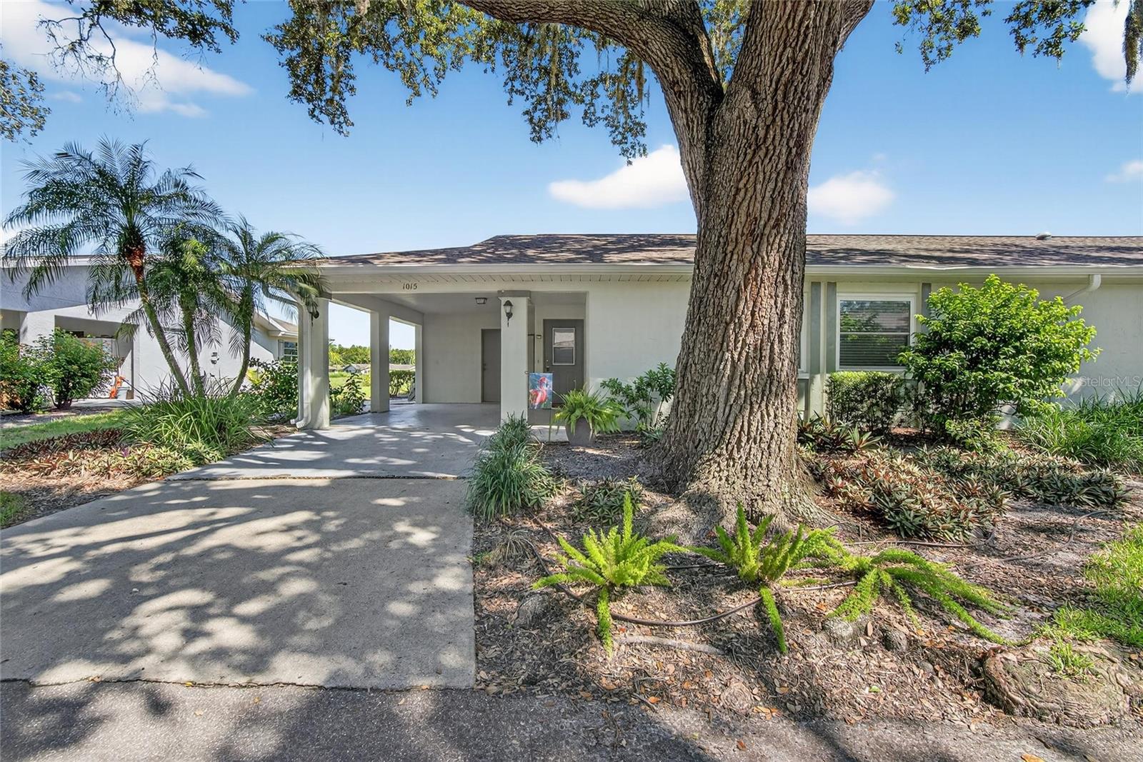 Located in the desirable Highgate F neighborhood of Kings Point, this furnished two bedroom, two bath condo offers peaceful golf course (not used) views and no rear neighbors. The spacious layout includes a bright family room with abundant windows, a primary suite with walk-in shower, and a guest room with built-in storage. Enjoy daily ease with an inside laundry room and extra storage. Step outside to a private paver patio, ideal for relaxing or grilling. Covered carport fits a vehicle and golf cart. Recent improvements include new carpet (6/2021), new hurricane windows (3/2022), new sunroom furniture (9/2021), new roof and gutters (1/2023) and new exterior paint (7/2025). Kings Point’s resort-style amenities include pools, clubs, restaurants and year-round activities. Perfectly located between Tampa and Sarasota, you’ll have easy access to shopping, dining, airports, entertainment, and award-winning beaches. Experience the best of 55+ living in Sun City Center—Florida’s top-ranked, most affordable active adult community!