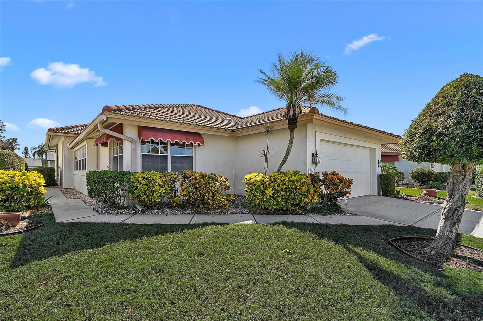Welcome to Peridia Golf & Country Club! This well maintained 2BR/2BA patio home offers easy Florida living in one of Bradenton’s most sought-after golf course communities. Sunlight pours into the home through generously sized windows, creating a bright and welcoming atmosphere. A large, screened lanai is perfect for relaxing or entertaining, and the low-maintenance lifestyle includes lawn care through the HOA. Step inside to find rich, wood flooring that warmly welcomes you in the entryway and flows seamlessly through the kitchen and charming eat-in area, adding a touch of elegance and warmth to the heart of the home. The kitchen features granite countertops, ample cabinet space, pull out drawers and a cozy eat-in breakfast area with an extra built-in counter—perfect for setting up a breakfast bar with coffee & bagels or wine and appetizers for evening entertaining. The primary suite includes a walk-in closet and an en-suite bath with dual sinks and a shower. The second bedroom is adjacent to a full guest bathroom, which also features dual sinks and a tub/shower combo. A split bedroom floor plan provides privacy for guests. From the clubhouse, golf course, heated pool, tennis courts, and full-service restaurant & Tiki bar, this home offers resort-style amenities year-round. New A/C and new screens on the lanai. Add your personal touch and make this home truly yours! Conveniently close to shopping, dining, airports and Gulf beaches. Enjoy resort-style living in this vibrant community featuring an 18-hole executive golf course, tennis and pickleball courts, a heated community pool, on-site restaurant, and a full calendar of members-only events and activities. Whether you're into golf, social events, or just relaxing by the pool, Peridia offers something for everyone to enjoy. Experience an active and engaging lifestyle in a beautifully maintained neighborhood. Fees include a $4,000 One Time Capital Reserve, $430 Qrtly Yard Maintenance, $877 Qrtly Master Association, $450 Annual food/beverage Minimum, and a $100 One Time Admin Fee to Peridia. Contact us to schedule your private tour today!