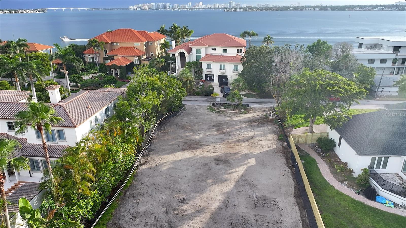 Rare Siesta Key Land Opportunity!
Location, location, location! This rare 13,939 sq. ft. (.32 acres) lot on Siesta Key offers a unique opportunity to build your dream home in one of the most sought-after areas. Just a short drive past the north bridge, this lot sits on one of the key's most established streets, surrounded by opulent, grand homes in the Bay Island neighborhood.
With the world-renowned Siesta Key Beach easily accessible and the convenience of the North Bridge within only a few minutes, this location offers both privacy and quick access to Southside Village, Downtown Sarasota, and all the attractions the area has to enjoy.
The lot has already been cleared and prepped for development, making it primed for your vision. Initial investments have been made, including storm debris clearing, house demolition, tree mitigation, and securing all the necessary permits.
The current developer is available to present existing plans for an elevated single-story residence or a two-story residence, should you prefer to modify the design. This is a truly rare opportunity to create a custom home in an unbeatable location!