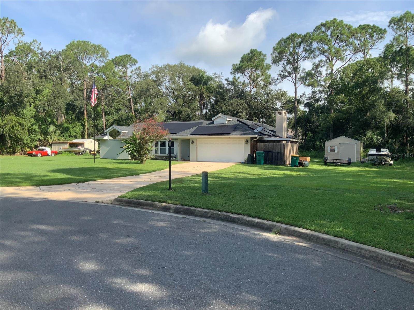 This picturesque neighborhood feels like you are so far from everything when your are home enjoying your space. Located just minutes to everything yet so peaceful. This pool home sits on just over one acre located in a cul de sac with so much space and potential to build on or just enhance what already exists. Split bedroom plan with a bathroom on one side to act as a bathroom for the two bedrooms and also a pool bath all at the same time. You have sliding doors from the family room, dining area and primary bedroom that all lead to the pool and pool patio area. There currently is solar panels connected to the home as well as a whole house generator for when the power goes out. New roof 2020, pool heater 2023, Air conditioning inside and outside unit 2024, septic holding tank and pump 2022 and generator 2021. The garage space is also air conditioned so if you have one or two classic cars you need in a safe spot, it's all ready and waiting. This home should be on the must see list. The one plus acre vacant lot next to the home is also currently on the market with the same owner. You could nake this a little family venture and buy both to buld on one and live on the other. Call me for a private showing.