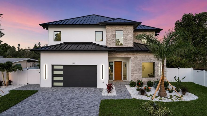 Not just another house…a carefully curated masterpiece, by Segatto Property Solutions Inc. Come experience the perfect blend of modern luxury, sophisticated design, and effortless Florida living in this stunning, newly completed, custom residence. This move-in-ready, two-story block home offers 4 bedrooms and 4.5 baths plus an office, thoughtfully designed with impeccable attention to detail, soaring ceilings, and an open-concept layout ideal for both everyday living and elevated entertaining.
From the moment you enter, you’re greeted by 10-foot ceilings throughout, with dramatic 22-foot ceilings in the great room that create a grand, light-filled space. The office and primary suite also feature 12-foot ceilings, adding an extra layer of refinement and comfort.
The designer kitchen is truly the heart of the home, showcasing quartz countertops, all Moen fixtures in bronze gold and matte black, a premium KitchenAid appliance package, custom cabinetry, walk-in pantry, and an oversized island that flows seamlessly into the great room and dining areas. Expansive sliders open to the outdoor living space, delivering the ultimate indoor-outdoor lifestyle.
Step outside to your fully fenced, private oasis featuring a heated saltwater pool, a fully equipped covered outdoor kitchen with grill and refrigerator, and an outdoor shower—perfect for entertaining or unwinding in total privacy.
The first floor primary suite offers a spa-like retreat with luxurious finishes, generous space, and a beautifully appointed bath; featuring dual shower heads, free standing tub and an oversized walk-in closet. Upstairs, Two additional en suits and a versatile loft area with a wet bar provides the perfect setting for a media room, lounge, or guest retreat.
Practicality meets luxury with a well-appointed first-floor laundry room featuring LG smart washer and dryer, additional built-in storage, and a utility sink.
Every detail of this home reflects quality craftsmanship and modern elegance, delivering the feel of a high-end model home without the wait. 
Ideally located in Arlington Park, near shopping, dining, beaches, and everything Sarasota has to offer, this exceptional home is ready for its first owners.
Schedule your private showing today…homes of this caliber, completed and move-in ready, are a rare opportunity.
