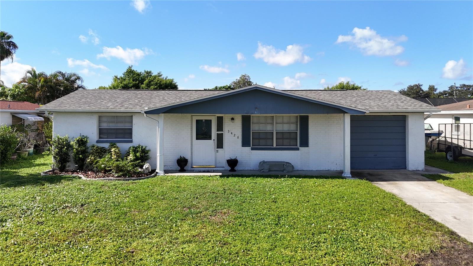 One or more photo(s) has been virtually staged. Move In Ready in Holiday Lake Estates. Whether you're a first time homebuyer, or need a seasonal get-away or are a Savvy Investor, this home fits the bill! Freshly painted w updated Kitchen and Bathroom, this home lives much larger than it's published square footage. Two spacious bedrooms with Ample sized closets PLUS large Bonus Room as Possible 3rd bedroom. As you enter you'll note that the tile flows seamlessly through all the main rooms and bedrooms- NO CARPET for easy maintenance. The kitchen has just been updated to include Modern White Cabinets with Quartz countertops to keep this home light and bright, the bathroom also has an updated Vanity & Countertops. The Bonus room is adjacent to the approx 15x10 Florida room w Ceiling Fan that looks out on your private back yard. NEWER ROOF 2022, NEWER A/C 2020 and NEWER Water Heater- all of this is located on a private fenced lot with NO HOA fees and Flood Insurance is NOT required! All that's needed is you. Call Today!